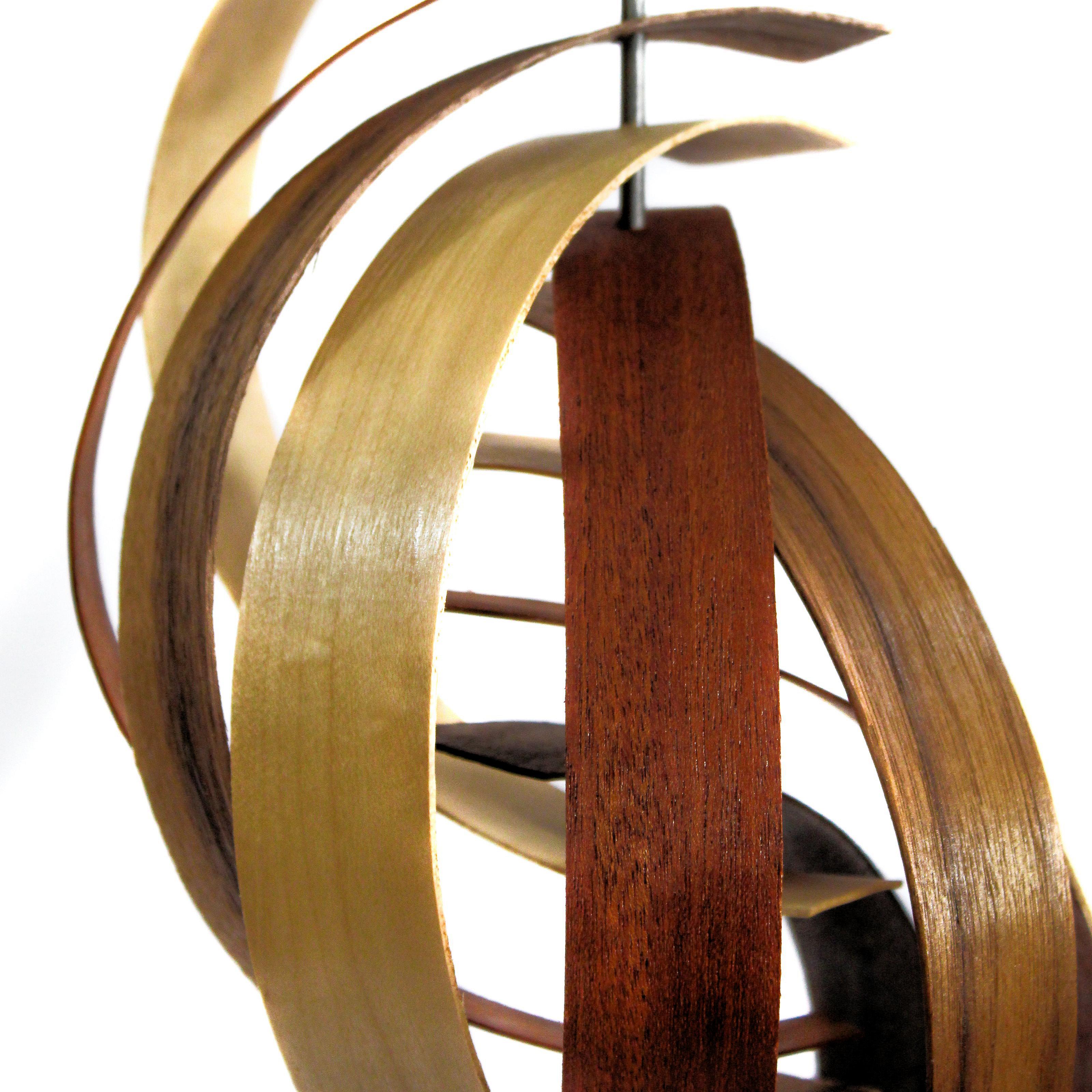 Description:  This sculpture consists of three tones of pre-formed walnut slats in a nautilus pattern. Walnut base. This sculpture is an open-edition multiple original; hand-made by the artist.
Title: Reach

Artist Bio:
Jeff was born and raised in