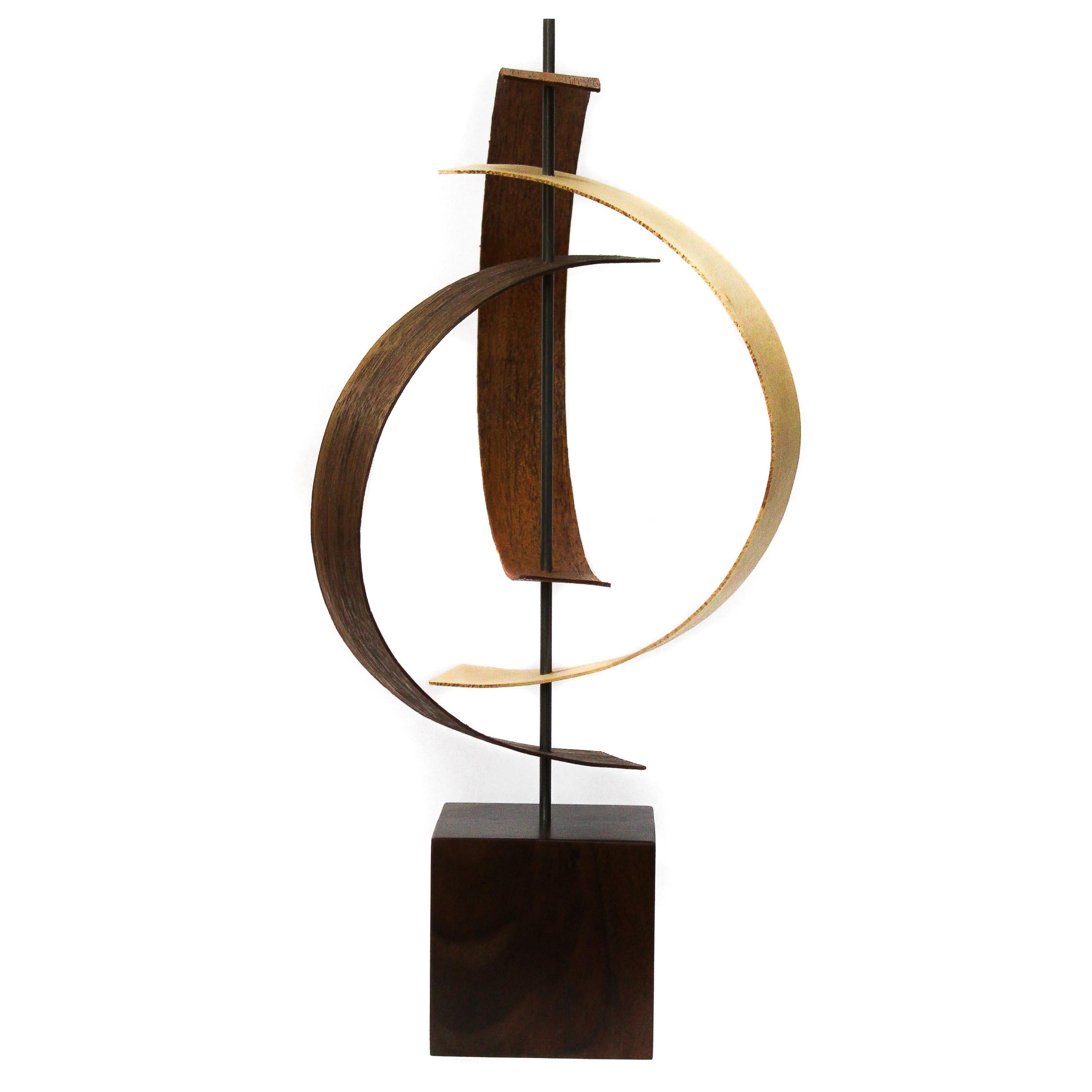 Description:  This sculpture consists of formed black walnut, mahogany pre-formed wood slats, with a solid walnut base.  This sculpture is an open-edition multiple original; hand-made by the artist.
Title: Origin

Artist Bio:
Jeff was born and