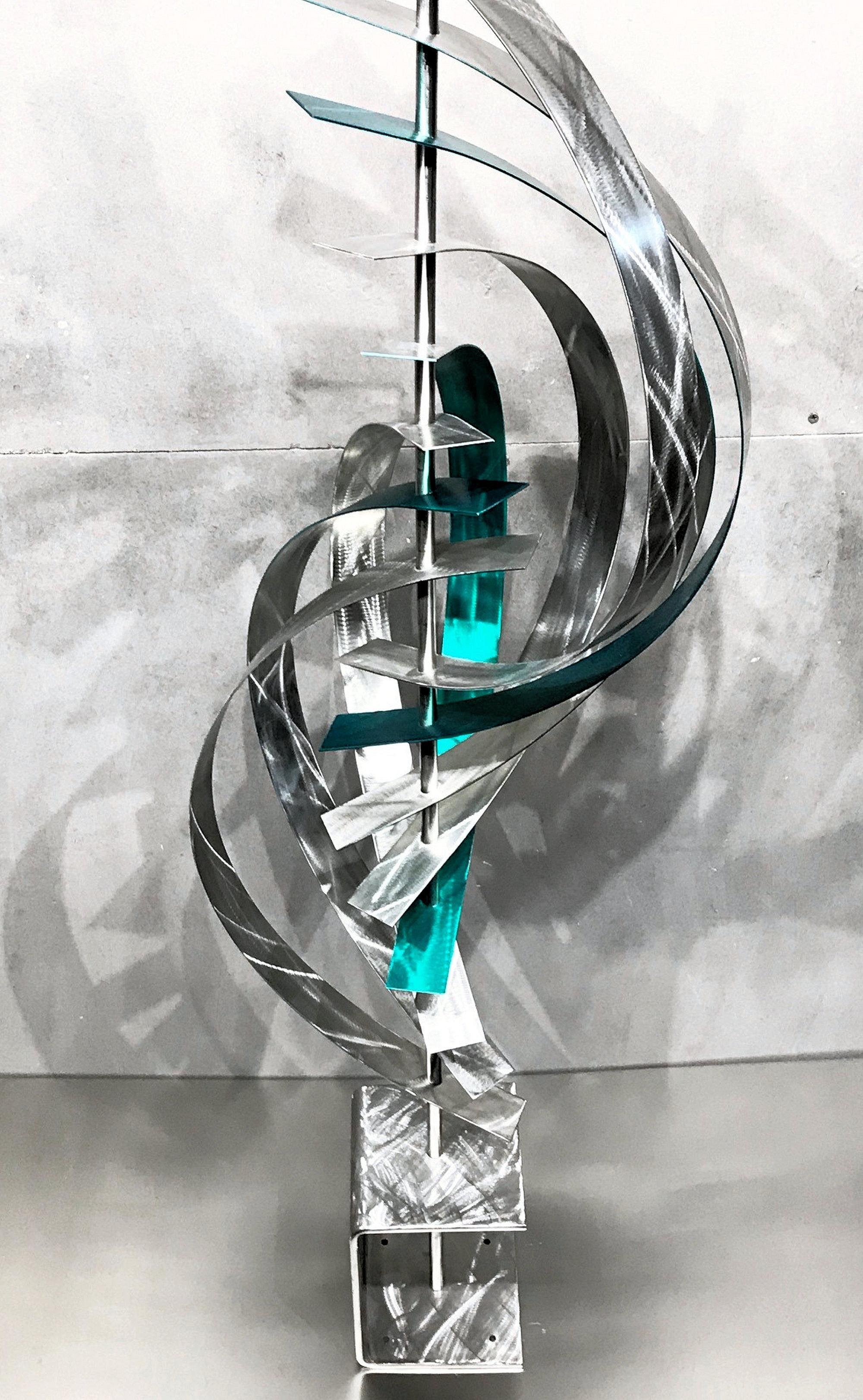 Description:  This sculpture consists of indoor/outdoor tinted stainless steel slats with unique grind patterns. Base consists of a single bent piece of stainless steel with grind pattern. This sculpture is an open-edition multiple original;