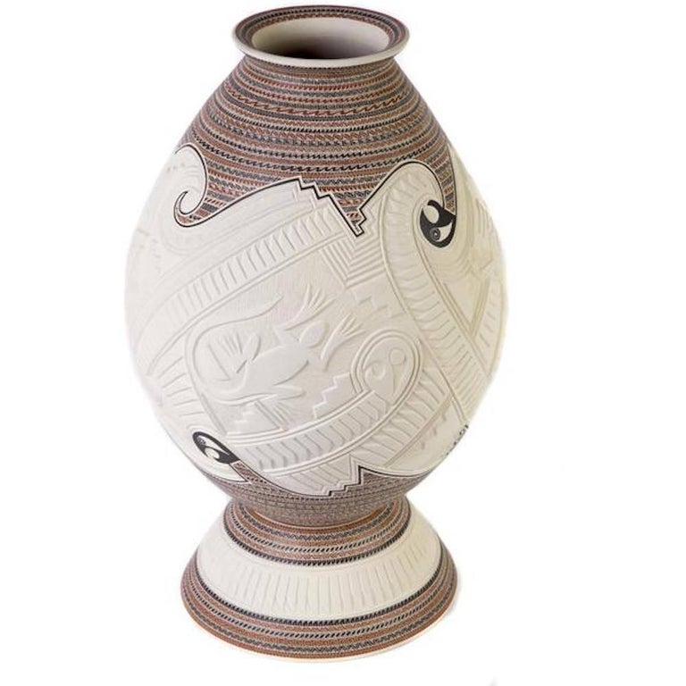 FREE SHIPPING WORLDWIDE!

Artisan: Martin Olivas Quintana
MASTERPIECE
Carved polychrome jar decorated with a sgraffito iguana, dragonfly, roadrunners and geometric design.

- Dimensions: 10" x 17" in or 25 x 42 cm
- Color: White
- Weight: 5 lb or
