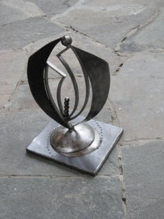“The Enfolding”, sweeping wings in welded steel tabletop form