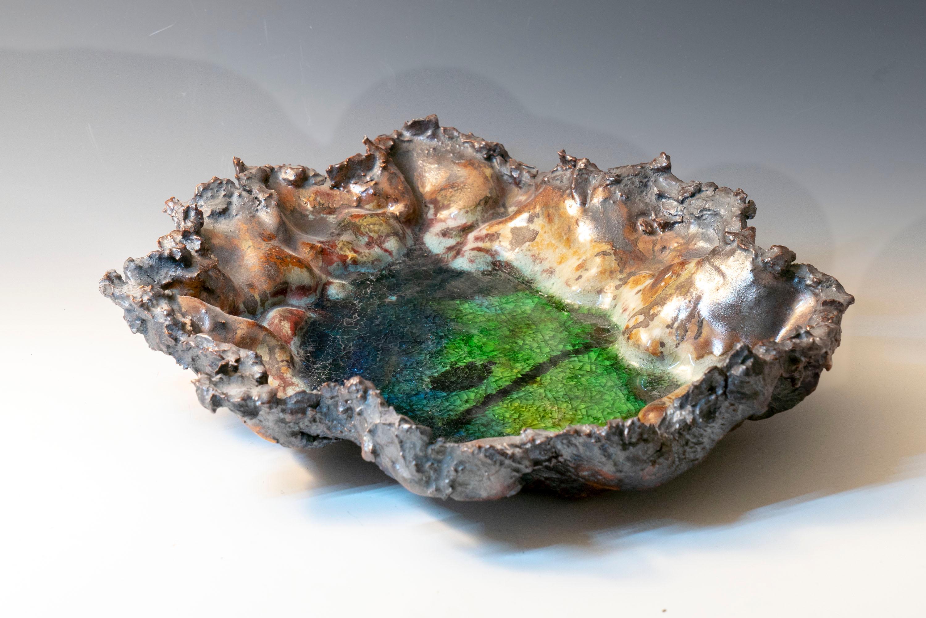 River Series 1, textured ceramic in brilliant greens and browns, embodies the essence of clay in its organic shapes that refer directly to the earth and nature. The artist says 