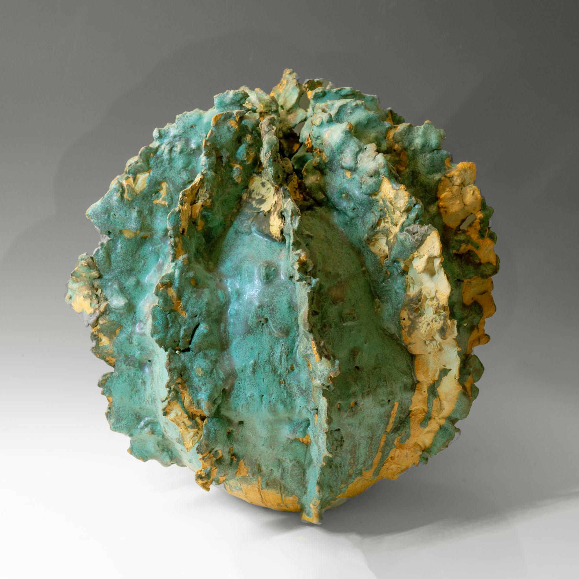 Ocean Discovery, textured ceramic glazed in water blue greens, embodies the essence of clay in its organic shapes that refer directly to the earth and nature. The artist says 