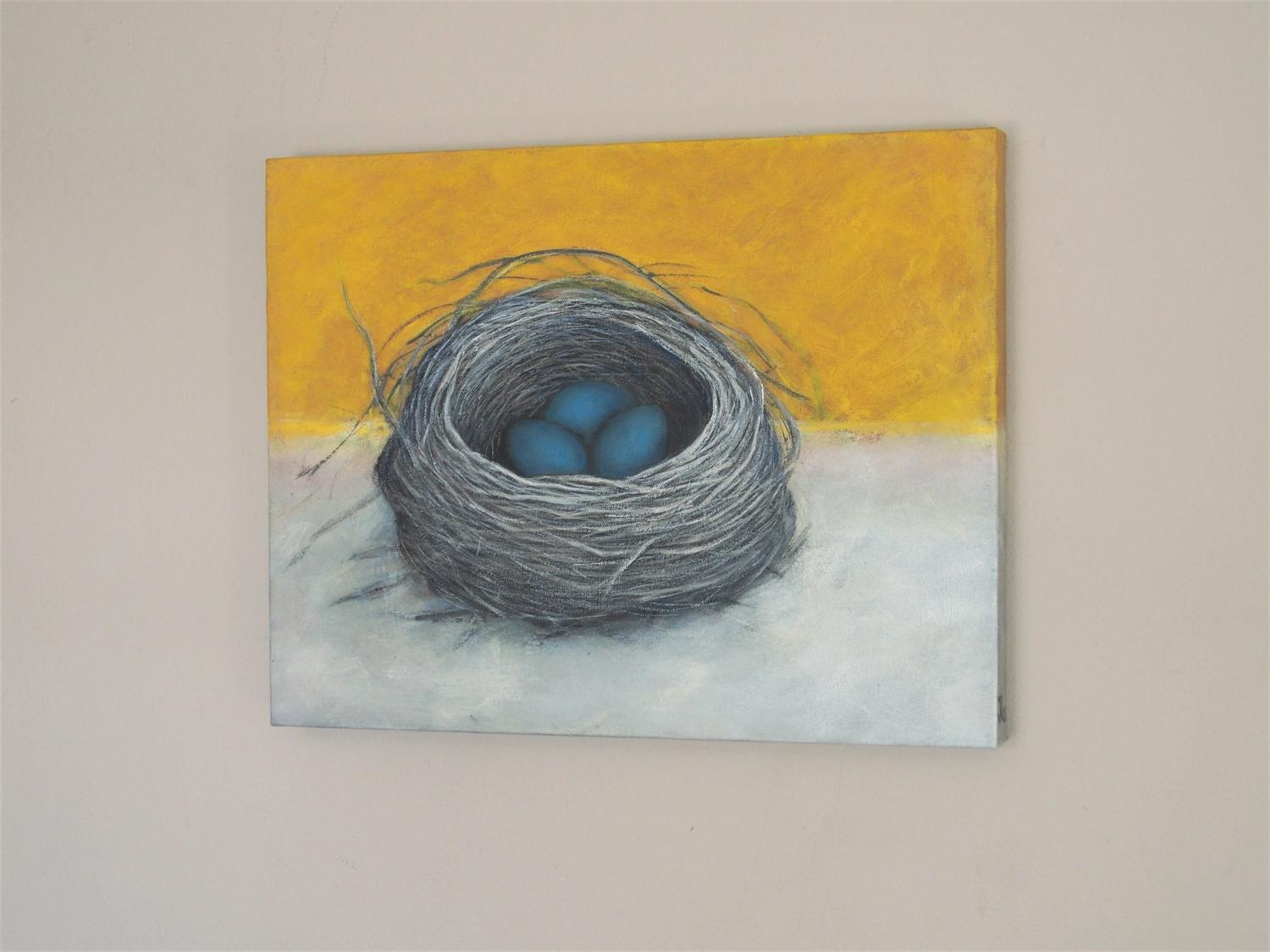 <p>Artist Comments<br>Artist Jennifer Ross paints a sunny and cheerful still life of a robinâ€™s nest occupied with three eggs. Nestled within a carefully woven nook of grass and twigs, three blue eggs appear within its dark recesses. The nest is