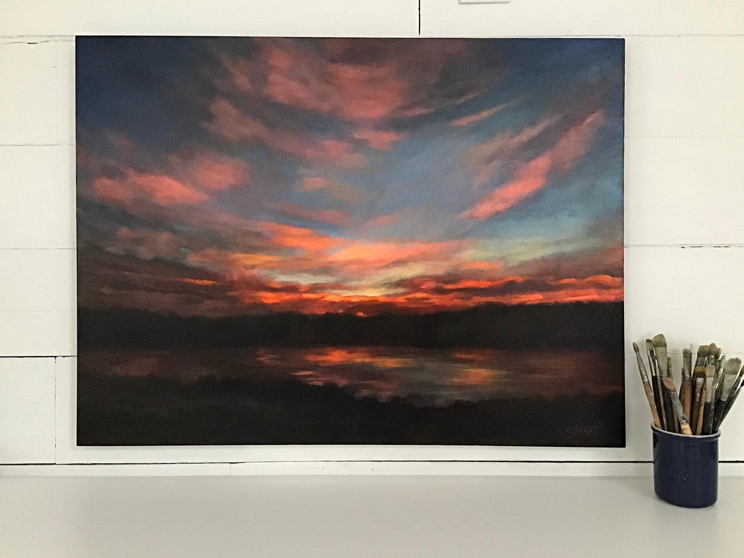 <p>Artist Comments<br>Artist Elizabeth Garat presents the last fiery rays of a sunset reflected onto the surface of the Mississippi River. The clouds glow from the remaining sunlight. She captures the majesty and power that appears to be lit from