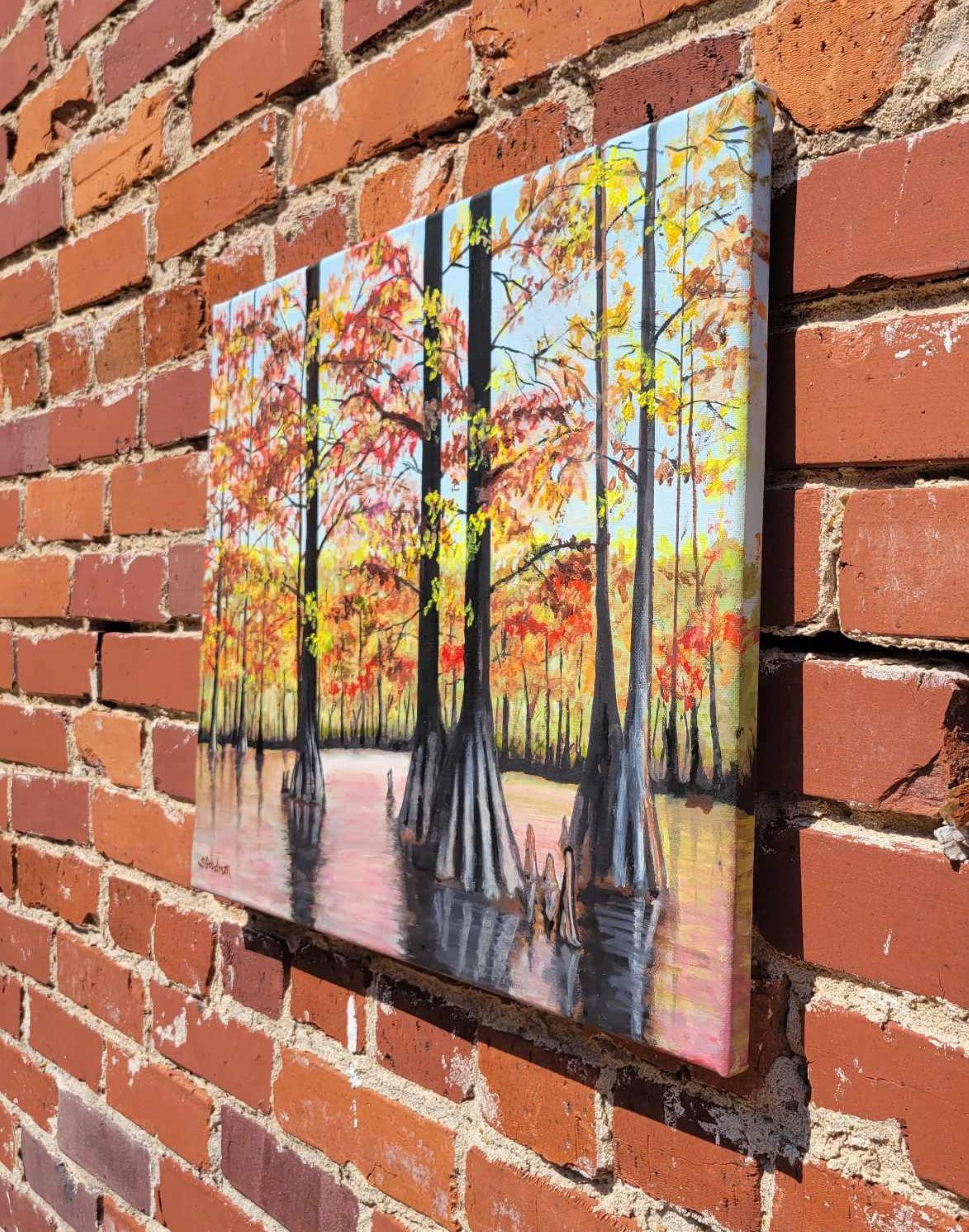 <p>Artist Comments<br>The painting depicts a serene autumn scene in the delta land of the Mississippi River. Towering cypress trees encircle the area, with the water hazily reflecting their yellow and orange-tinted leaves. The composition exudes a