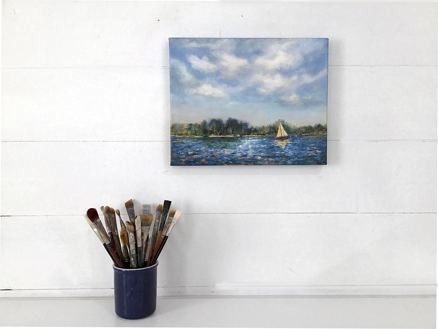 <p>Artist Comments<br>Billowing clouds float above an impressionistic lake. The yellow sail of a lone boat reflects on the choppy water, capturing the interplay of light and texture. The mostly cool palette with touches of warm yellows infuses the