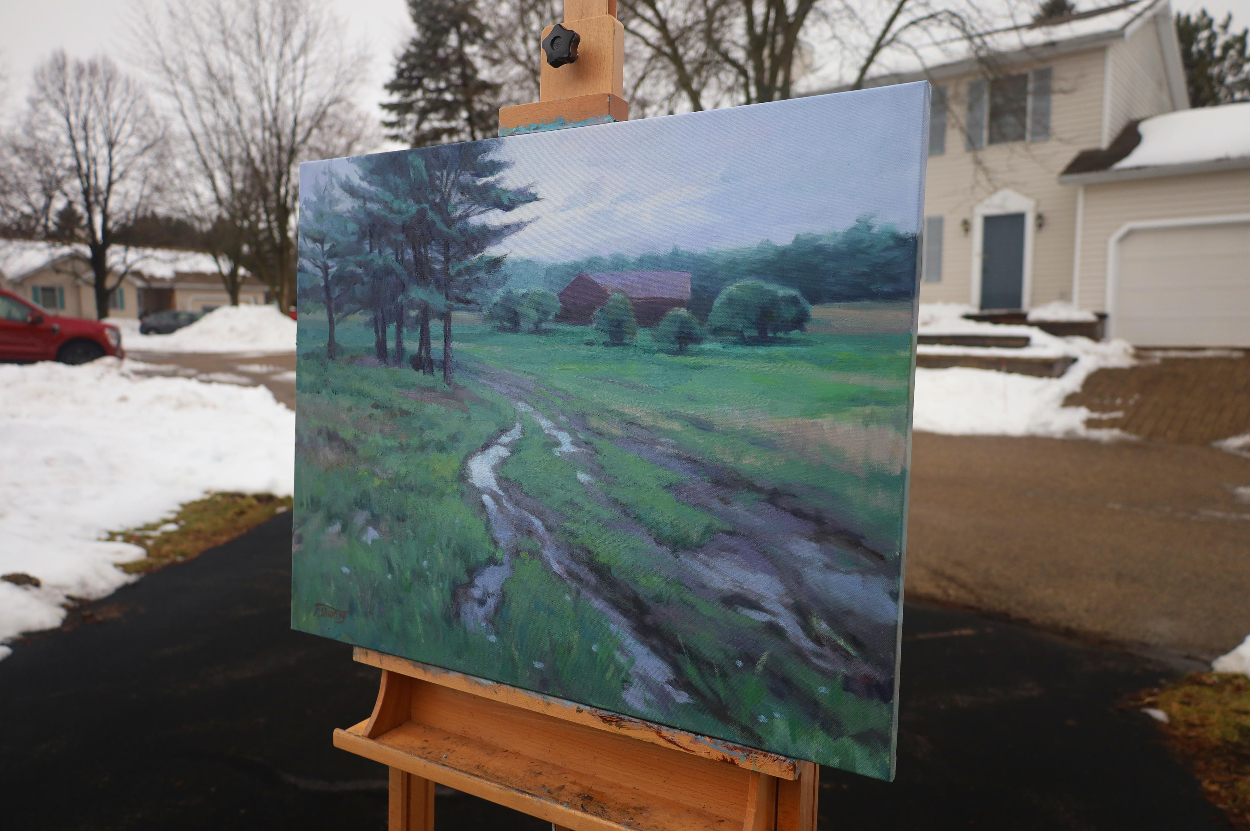 <p>Artist Comments<br>A muddy road cuts through a farm, winding across a grass-covered ground. The cloudy sky reflects on the puddle in the foreground, while a red house in the distance creates a subtle point of color amidst the greens. The soft