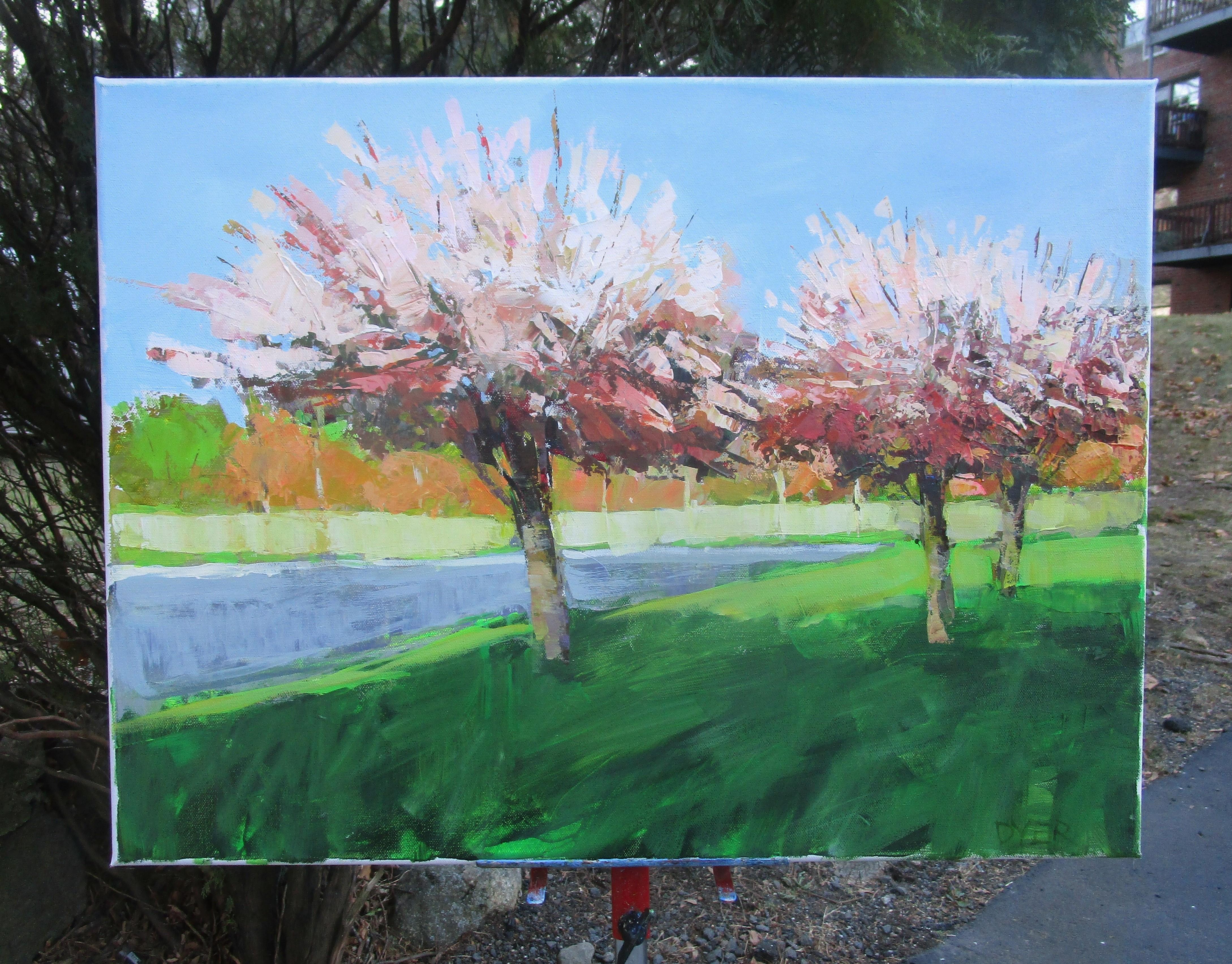 <p>Artist Comments<br />Trees burst with charming pink and white leaves under a clear blue sky. They stand beside a pavement, surrounded by vibrant green grass and orange foliage in the background. Painted with a palette knife and brush, the bold