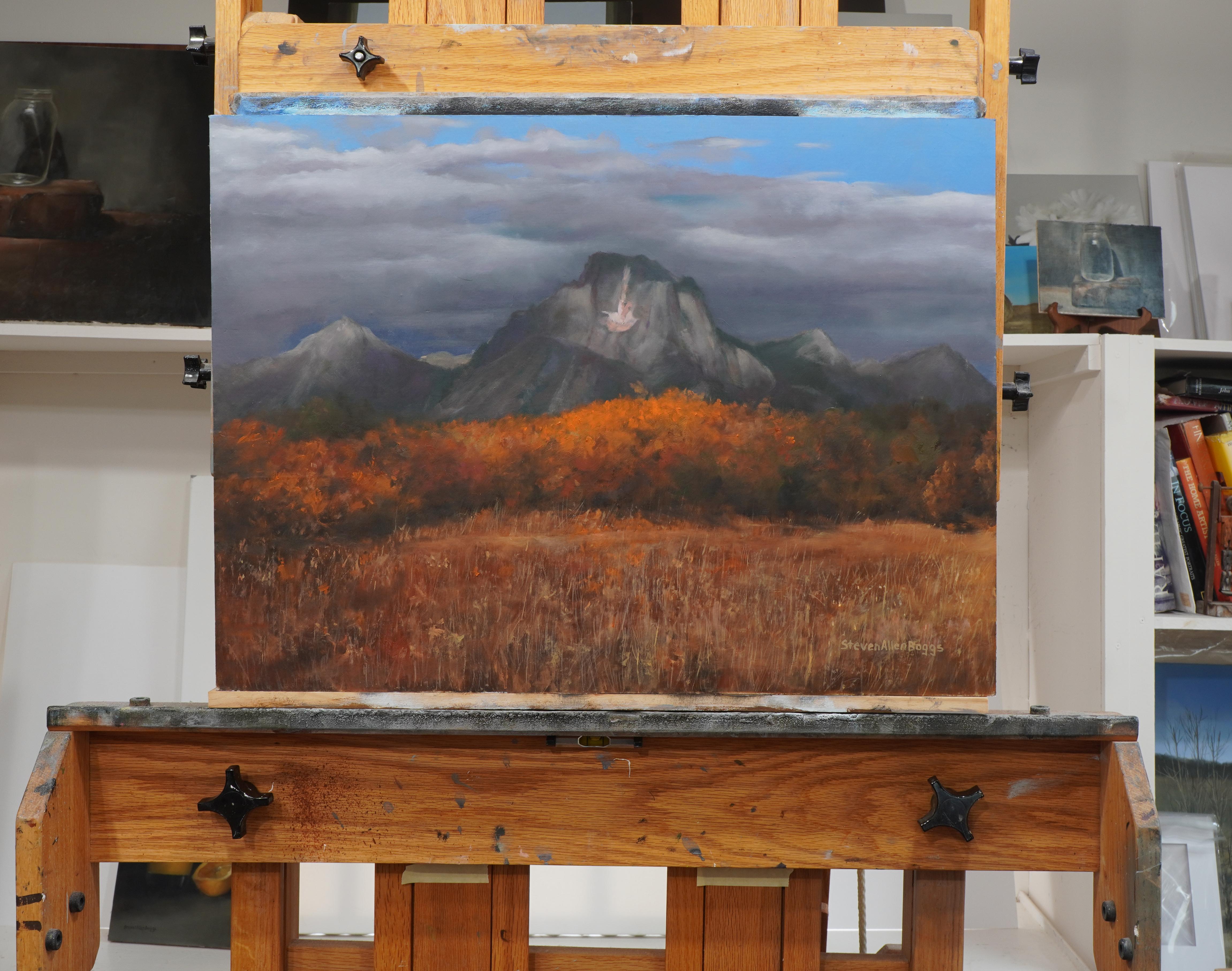 <p>Commentaires de l'artiste<br>Les montagnes s'élèvent avec une présence imposante, dominant le paysage du soir du parc national de Teton. Une ligne d'arbres vibrante au premier plan brille de riches teintes automnales, contrastant avec les nuages