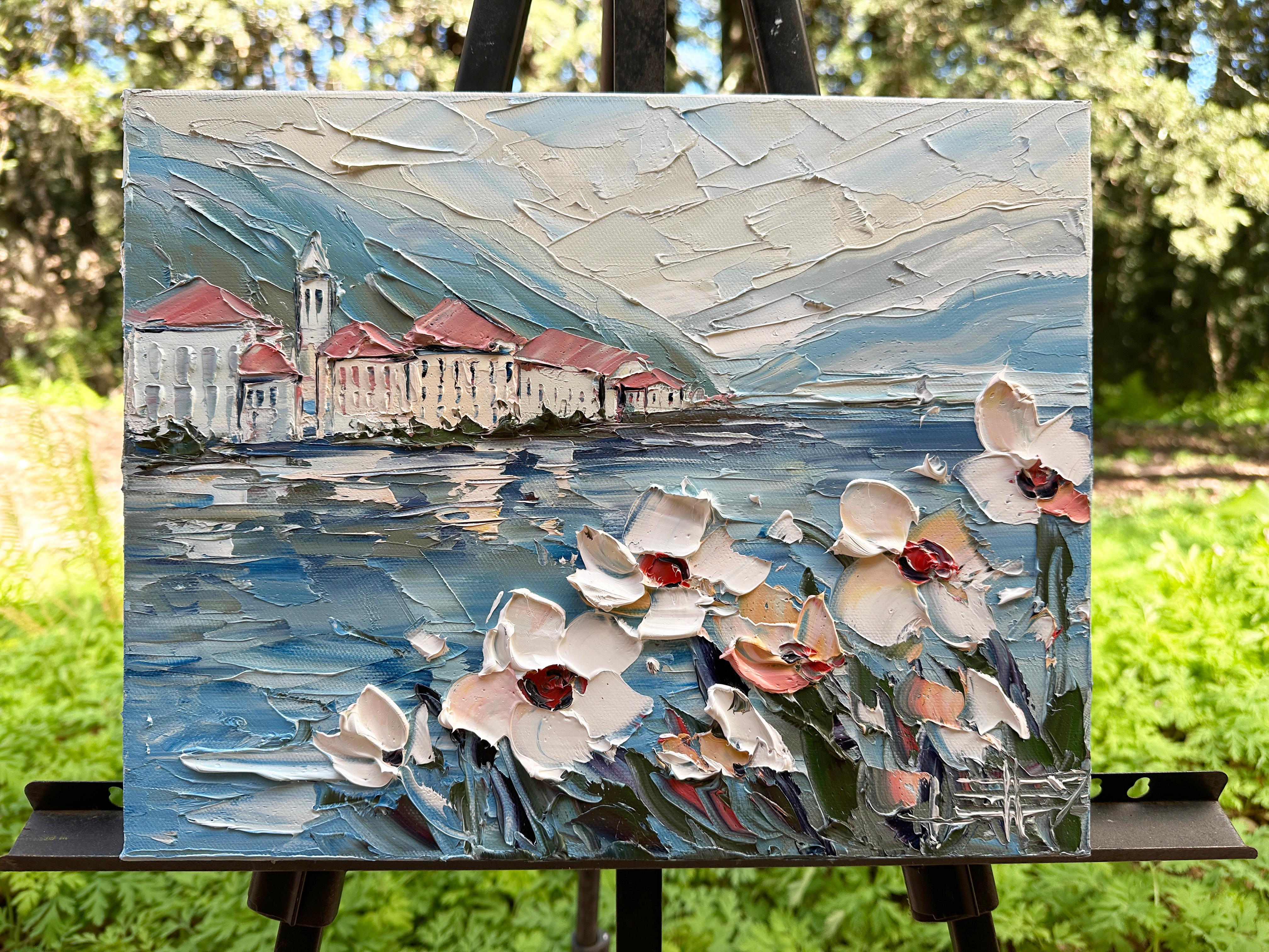 <p>Artist Comments<br>Bathed in soft golden light, this dreamy painting captures the serene beauty of Lake Como. Gentle reflections ripple across the water as distant villas nestle into the hills, wrapped in hazy blues and warm blush tones. With an