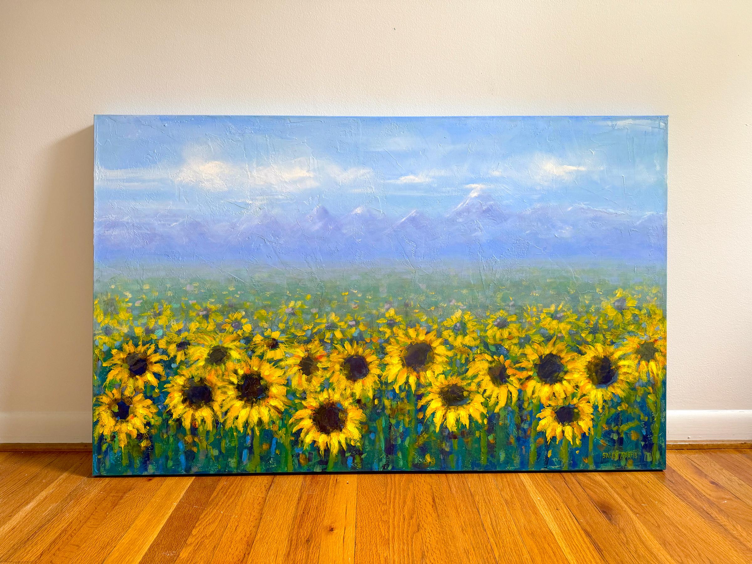 <p>Commentaires de l'artiste<br>Une abondance de tournesols fleurit dans un champ tentaculaire. Leurs pétales dorés brillent sous le soleil d'été. Des montagnes imposantes s'élèvent au loin, tandis que le ciel brumeux les peint dans des tons doux et