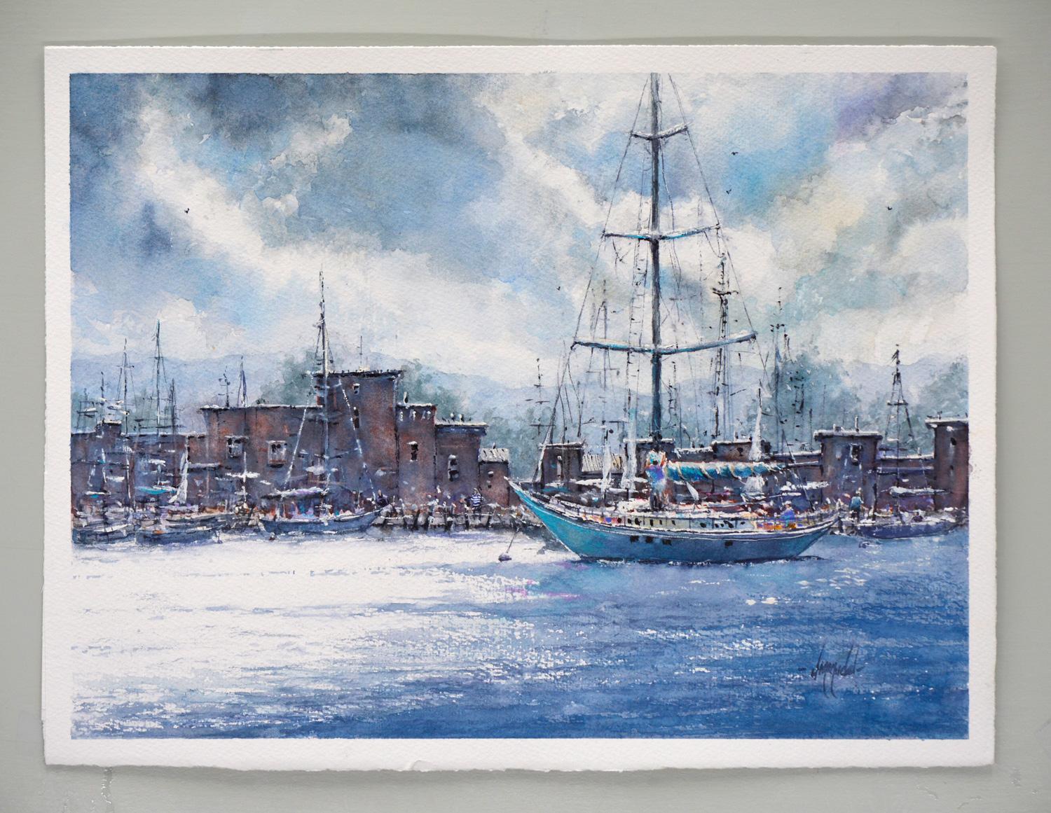 <p>Artist Comments<br>The artwork captures a quiet moment along a busy harbor, where the steady presence of a tall sailboat anchors the scene. In the distance, brick buildings and smaller vessels crowd the quay, suggesting a lively waterfront. The