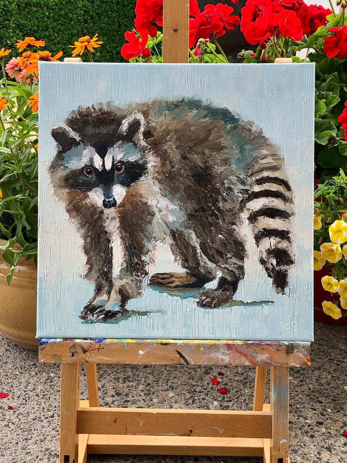 <p>Kommentare des Künstlers<br>Ein Waschbär steht vor einem sanften blauen Hintergrund, sein neugieriger Blick ist voller Leben. Die KÃ¼nstlerin Karen Barton wurde durch den Charme und die Cleverness der Tiere inspiriert. Mit Spachtel und
