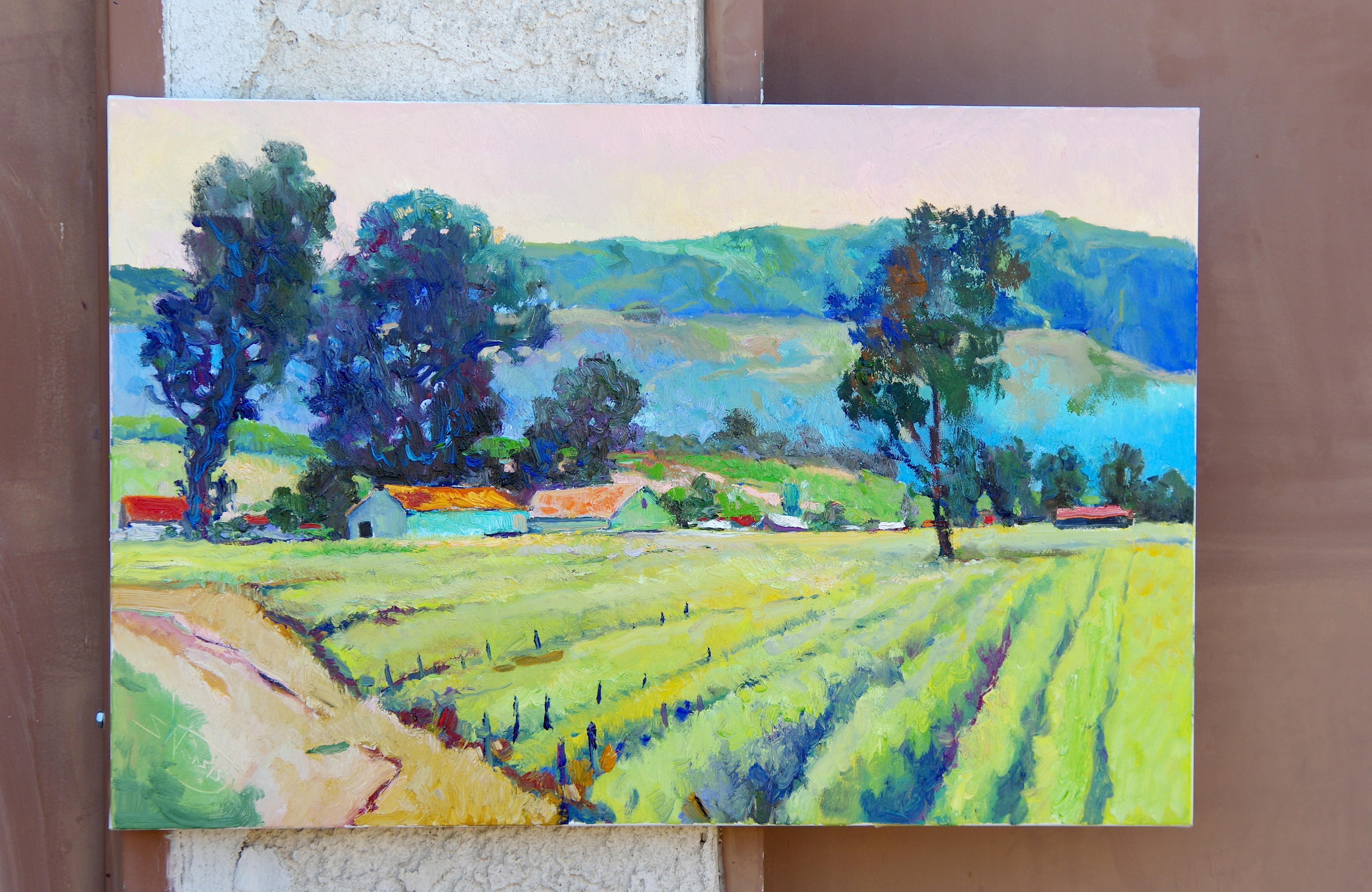 <p>Artist Comments<br />Morning light across a northern California vineyard. A pastel pink and yellow sky presides over a delicate array of blue and green hills and trees. Bright red and orange rooftops draw the eye back. Suren travels extensively,