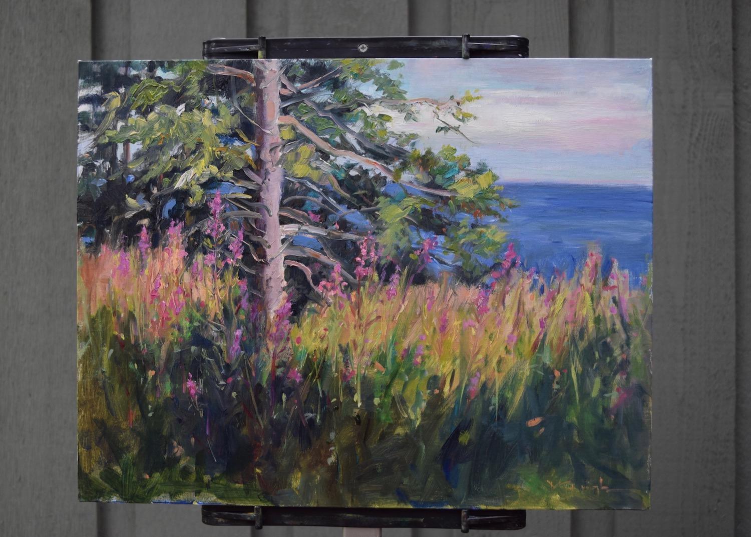 <p>Artist Comments<br />Mickey Cunningham painted this sunny landscape on location on the shore of Lake Superior. She says that the colorful flower in the scene, the purple loosestrife, is very pretty but also an invasive plant. Mickey applied rich