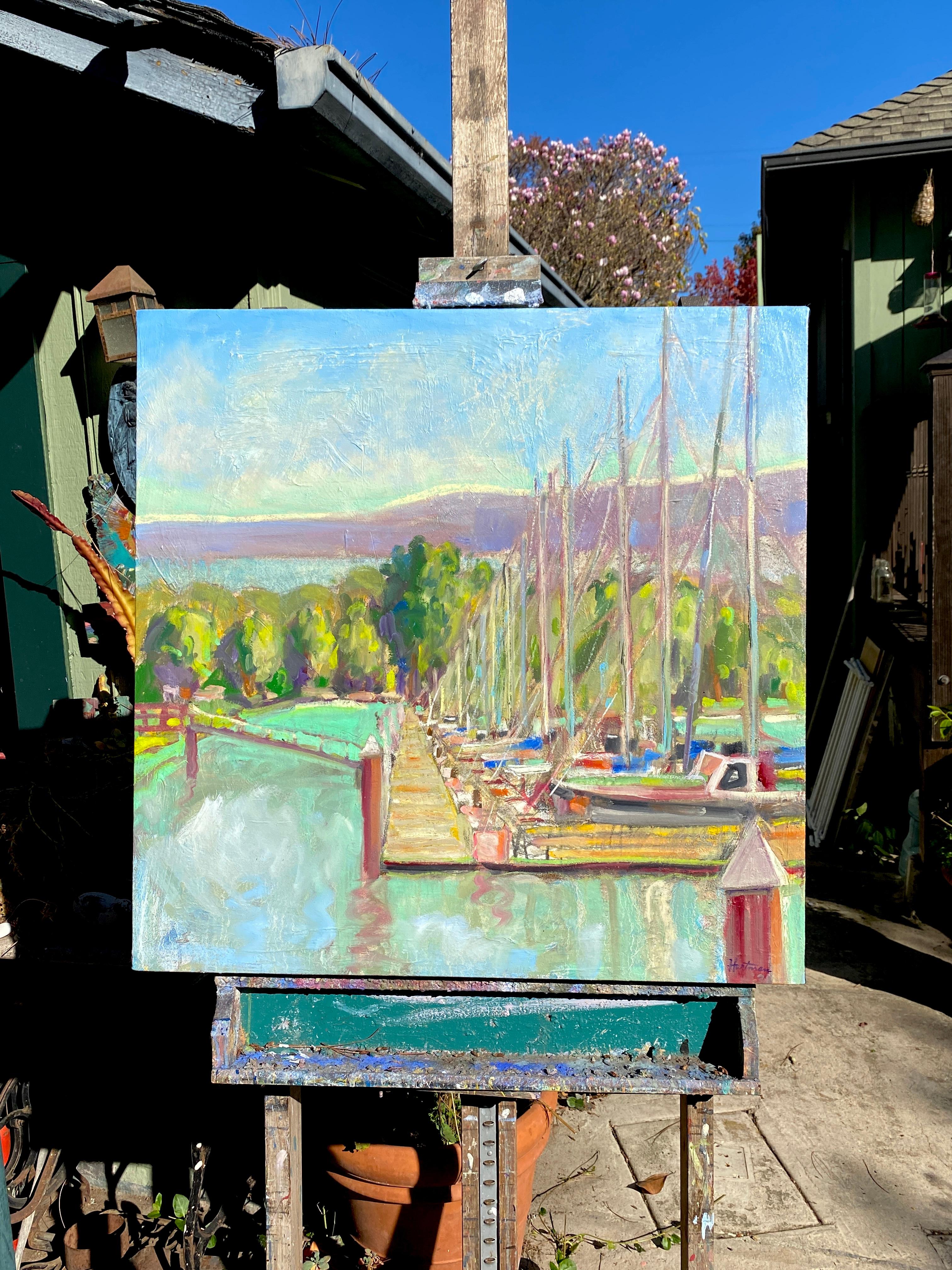 <p>Artist Comments<br>Artist James Hartman depicts a group of sailboats docked neatly on the harbor. Glistening turquoise waters sway gently before a vivid green forest. Broken colors of red, blue, and yellow accentuate the boats and masts as they
