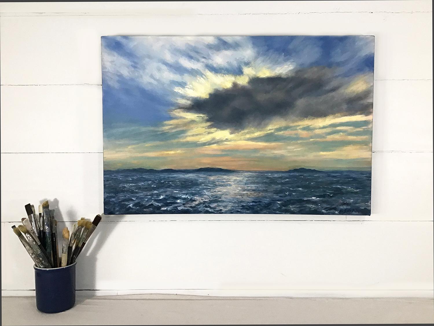 <p>Artist Comments<br>Artist Elizabeth Garat paints a dramatic view of the sky above the vast ocean's choppy waters and distant coastal islands. The brilliant rays of the sun illuminate the atmosphere and create a vibrant glow surrounding the edges