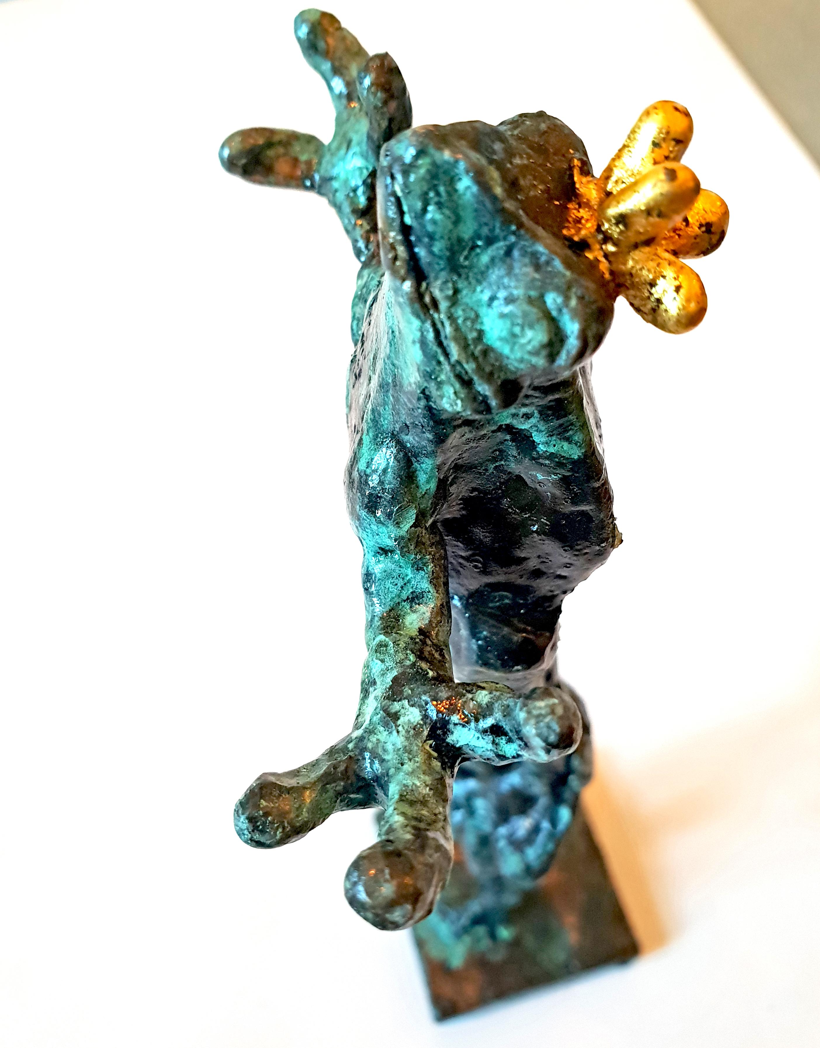 Bronze sculpture of a frog carried on a woman's shoulders