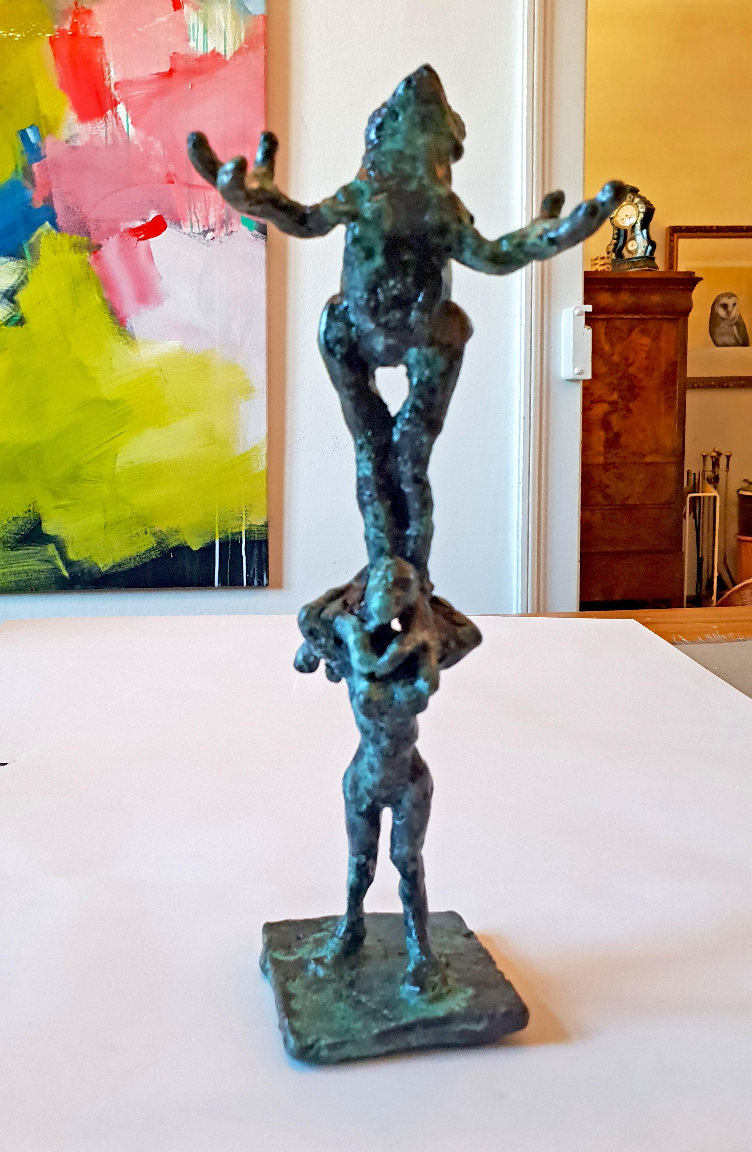 Frog Acrobatics by Helle Crawford, Bronze sculpture of a frog carried by a woman 1