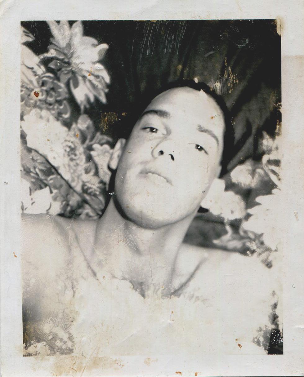 Mark Morrisroe Portrait Photograph - Untitled (Portrait of Robert in Front of Floral Fabric)