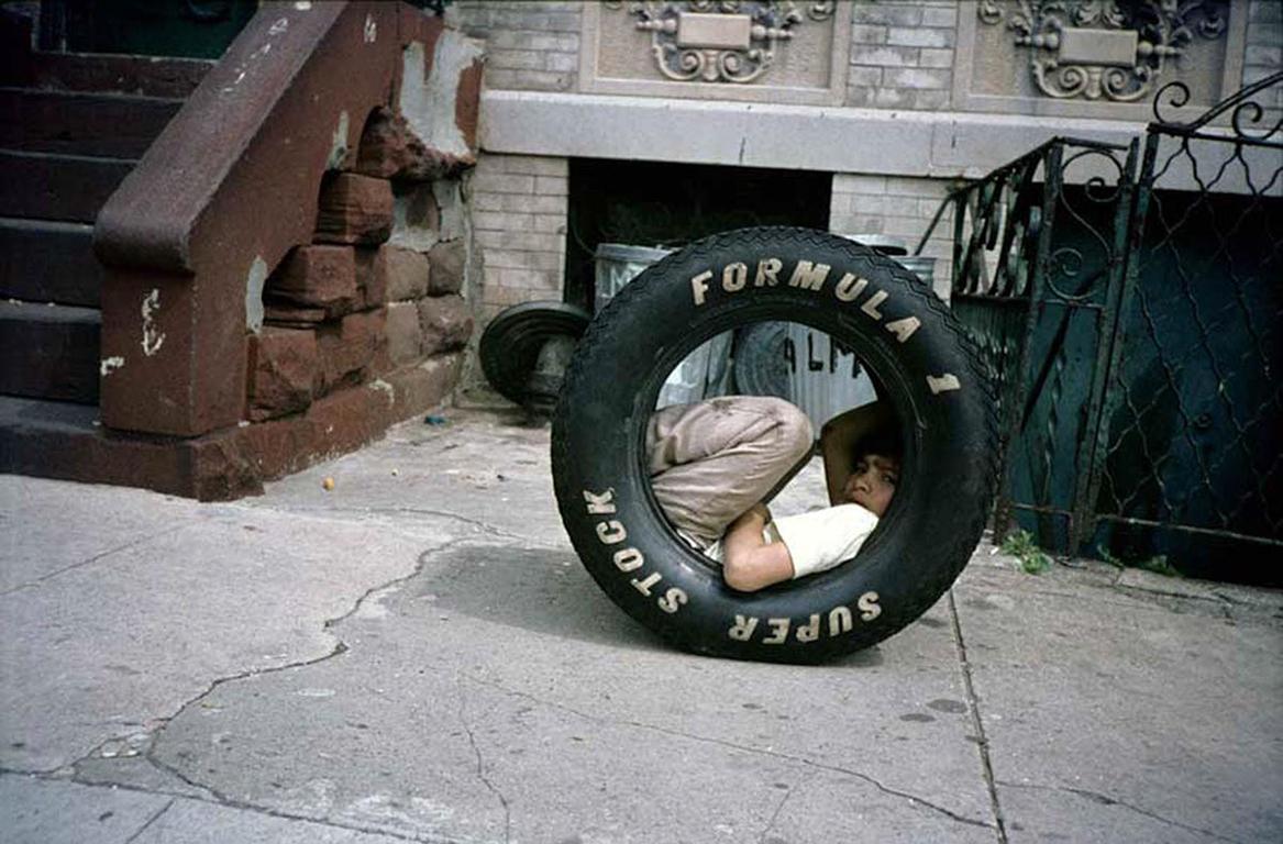Meryl Meisler Portrait Photograph - Boy in a Tire