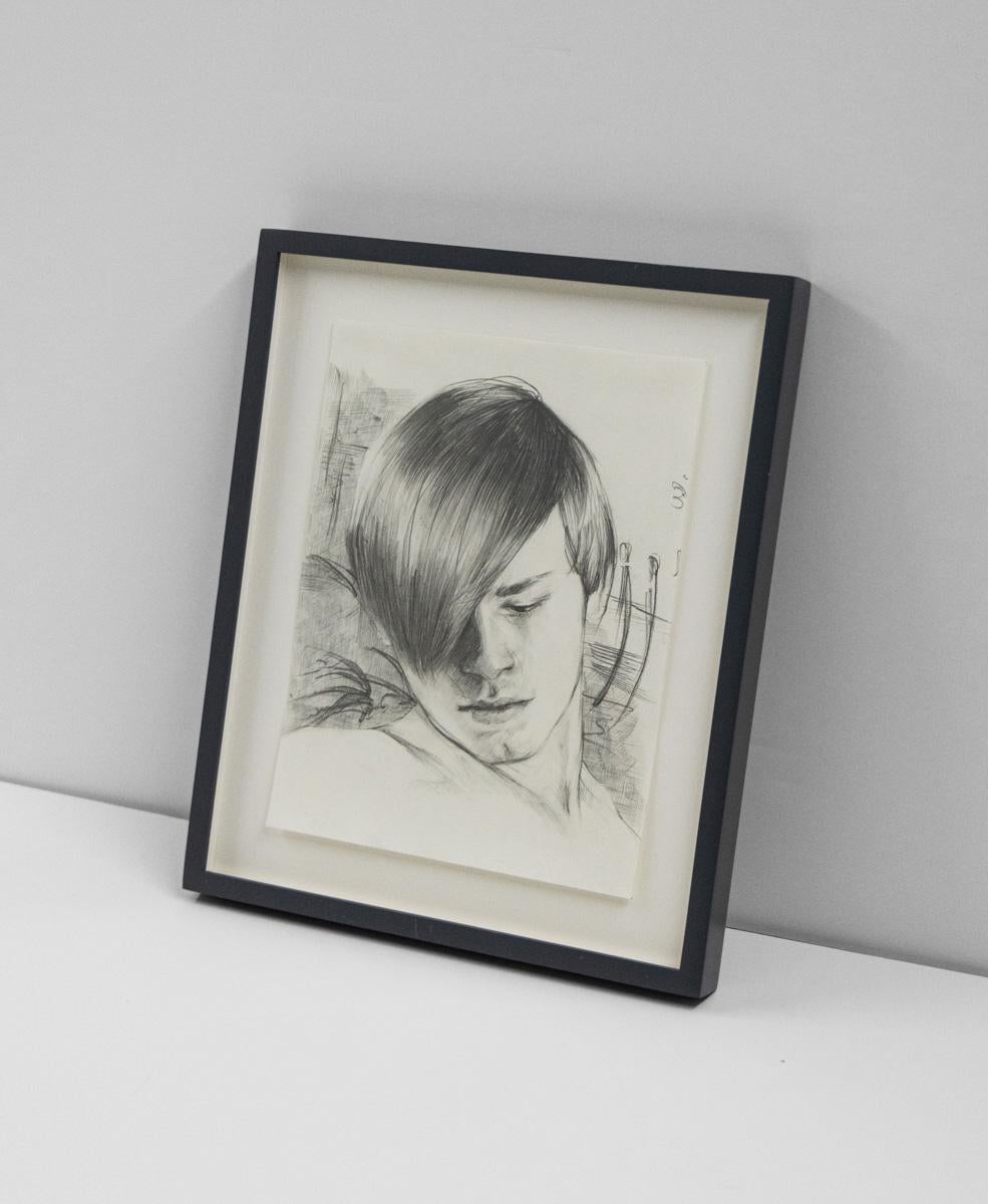 boy looking down drawing