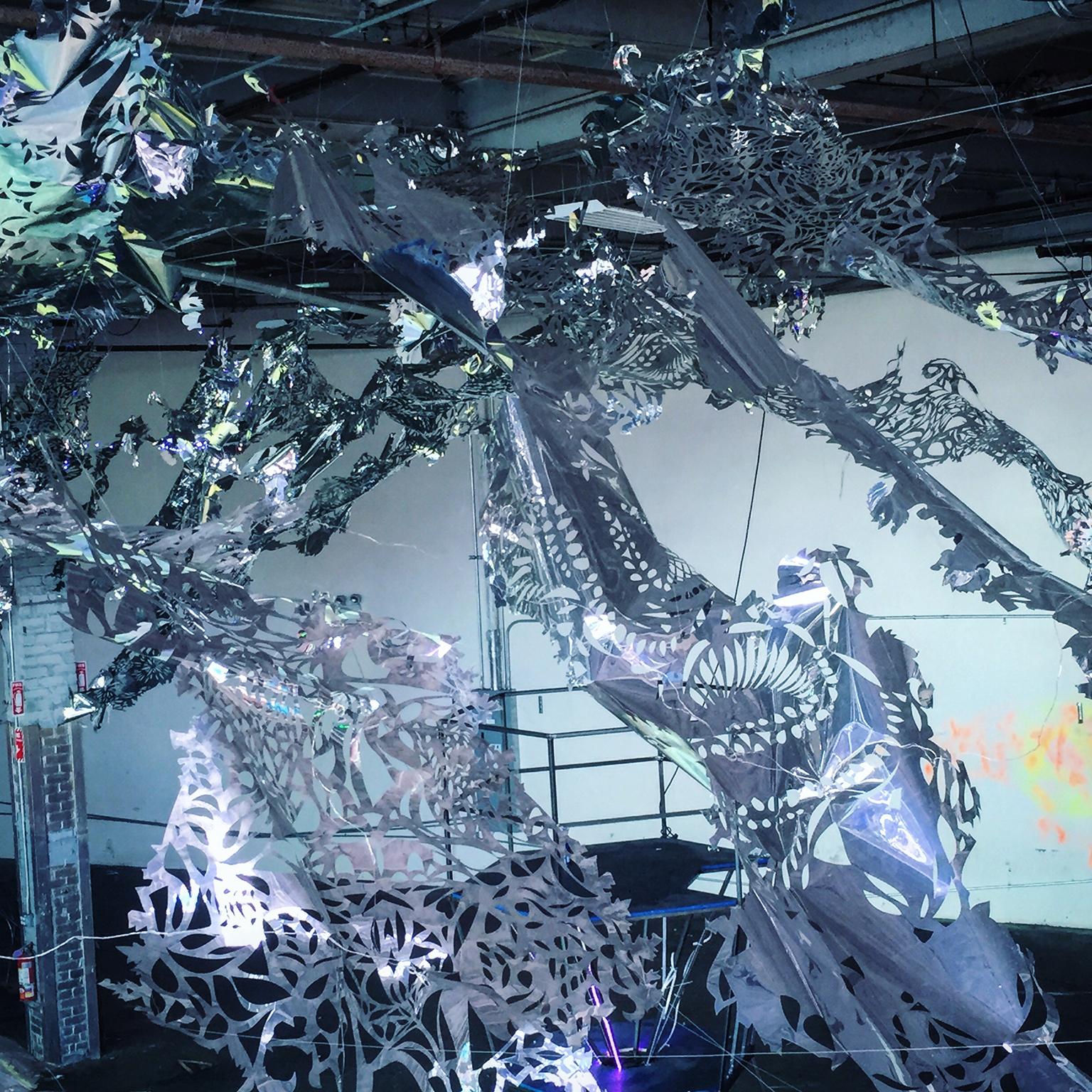 Medium: hand cut mylar

Julia Sinelnikova is an interdisciplinary artist who works with holograms, performance, and digital culture. Her light installations have been exhibited internationally, and she has performed widely as The Oracle of Vector