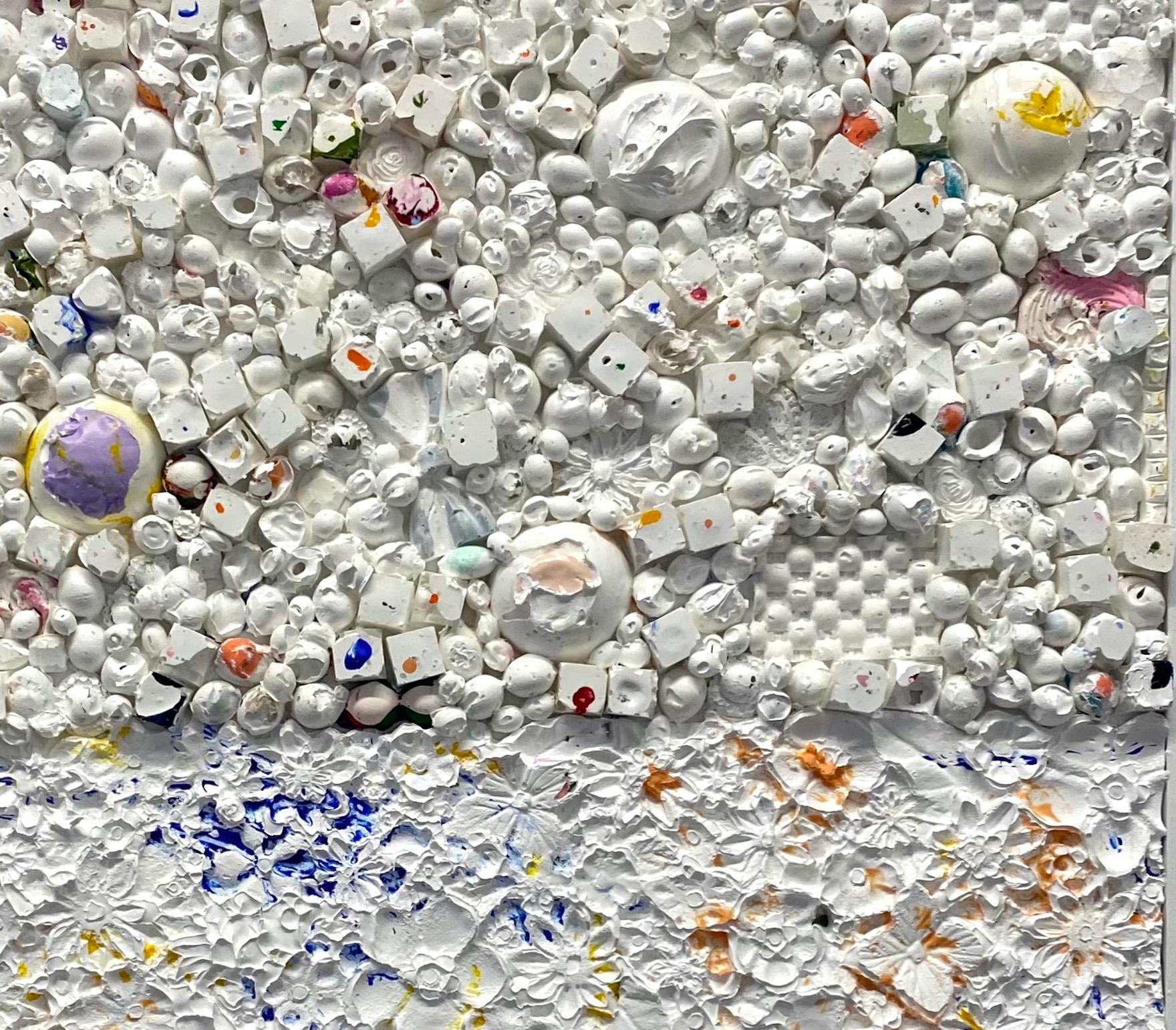 This heavily textured painting by Natalie Harrison is composed of hundreds of small acrylic molds. In this painting, she utilizes white acrylic paint to layer on top of brightly colored acrylic molds. The discrepancies in texture create a highly
