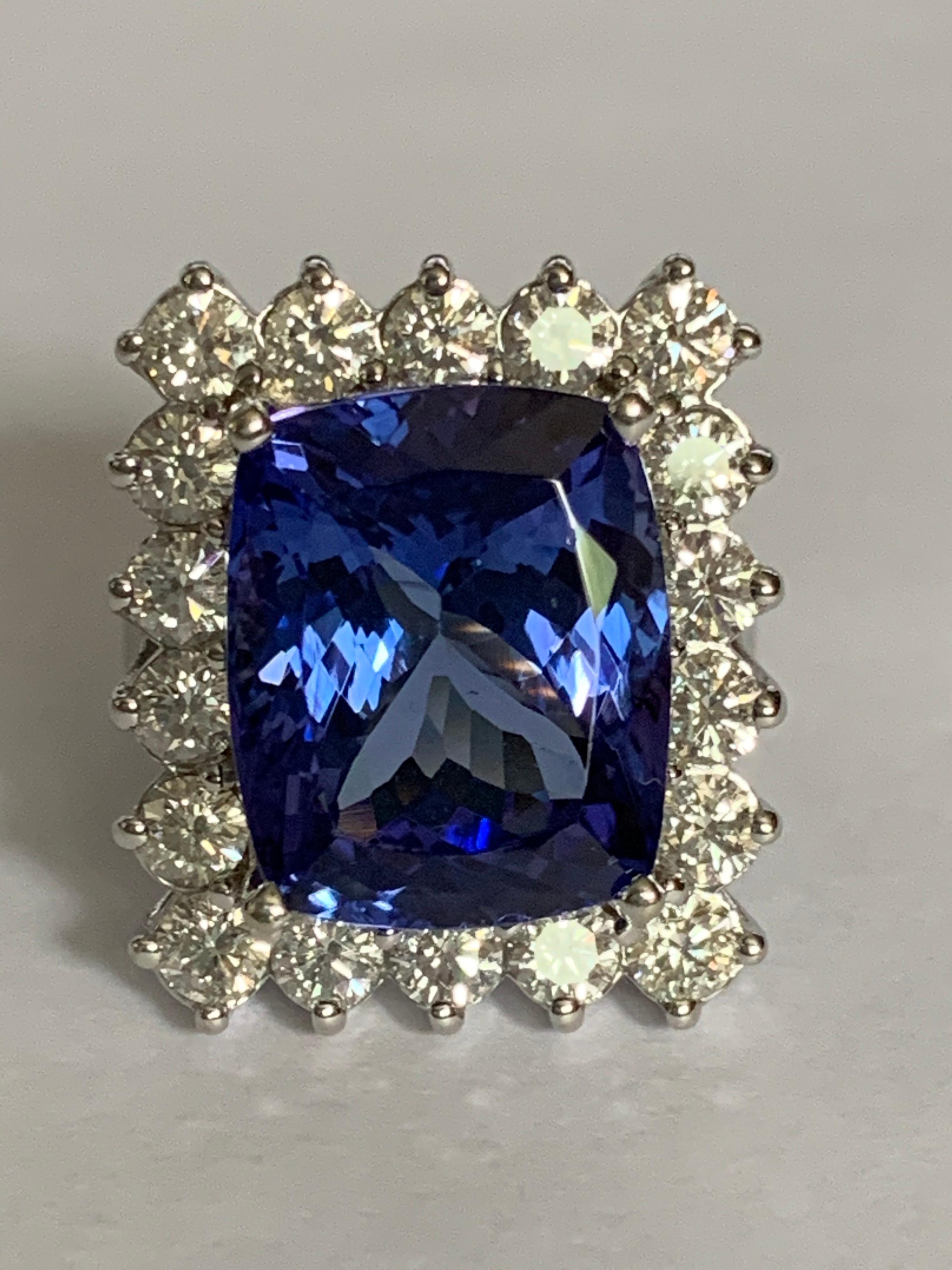 Natural 14.62mm X 11.98mm 10.35 carat Tanzanite with 18 diamonds 2.15 Carat set in 18 karat white gold is handcrafted Ring. 
The quality of Tanzanite is AAA and all the diamonds are SI or better .F/.G color .
The ring is exceptional and you will