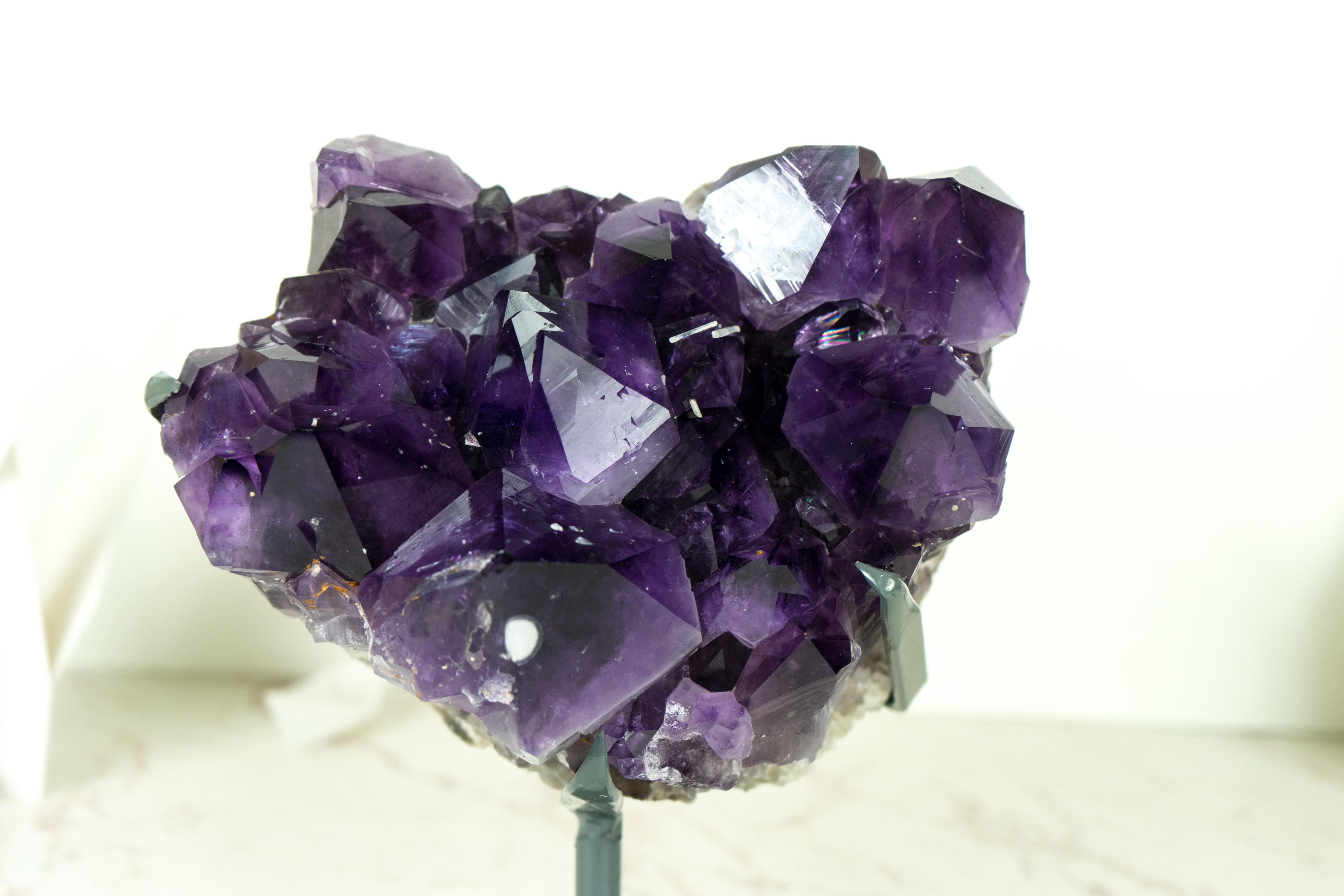 An Amethyst Cluster with gorgeous aesthetics, bringing the deepest tone of Purple of any Amethyst, and rare cristobalite inclusions, this Amethyst Cluster elevates every aspect of Brazilian Amethyst and is ready to become a conversation starter in
