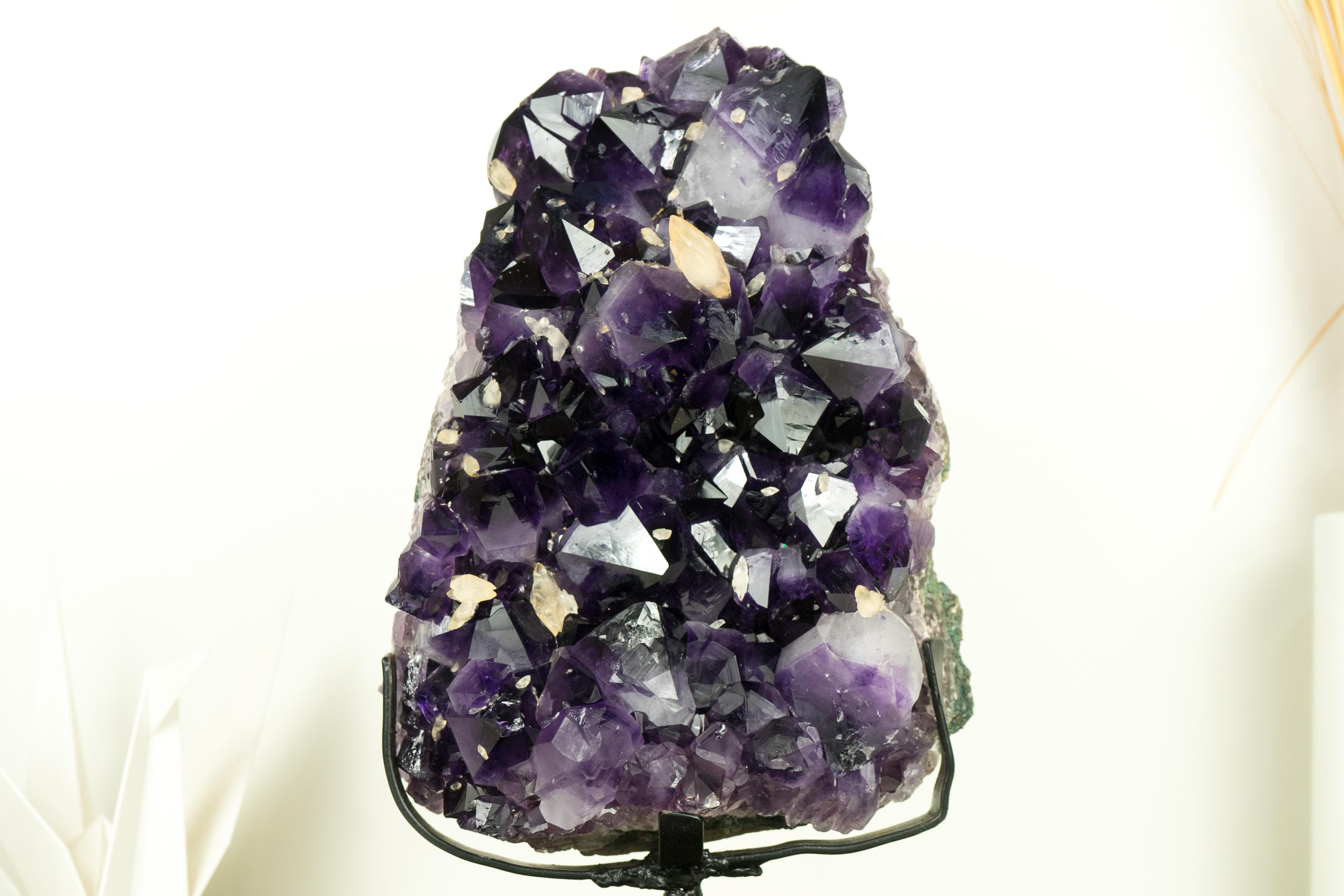 A gallery-grade amethyst cluster that delivers world-class aesthetics to be the centerpiece of your collection. This Amethyst features large, super saturated dark druzy as well as double-terminated calcite inclusions, making it an exceptional