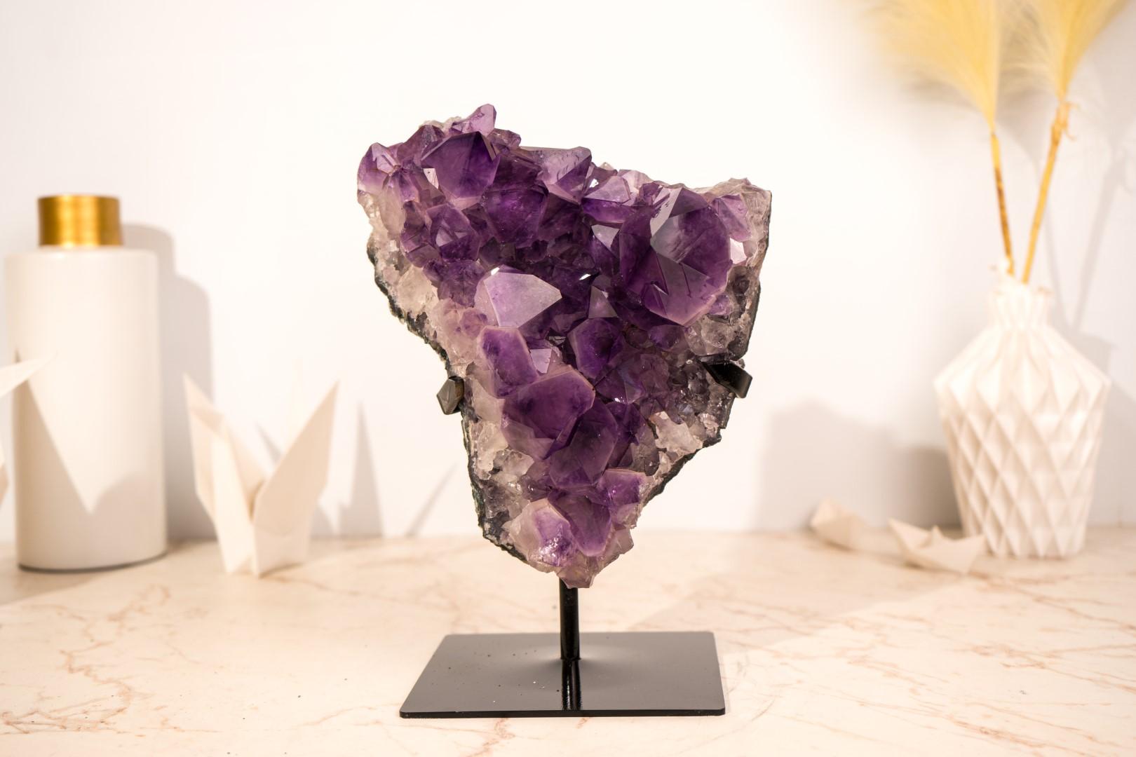 Presenting a stunning AAA amethyst cluster with beautiful characteristics and aesthetic appeal, this specimen is an absolute gem, sure to become the centerpiece of your collection, Feng Shui arrangements, altars, or décor.

What first draws