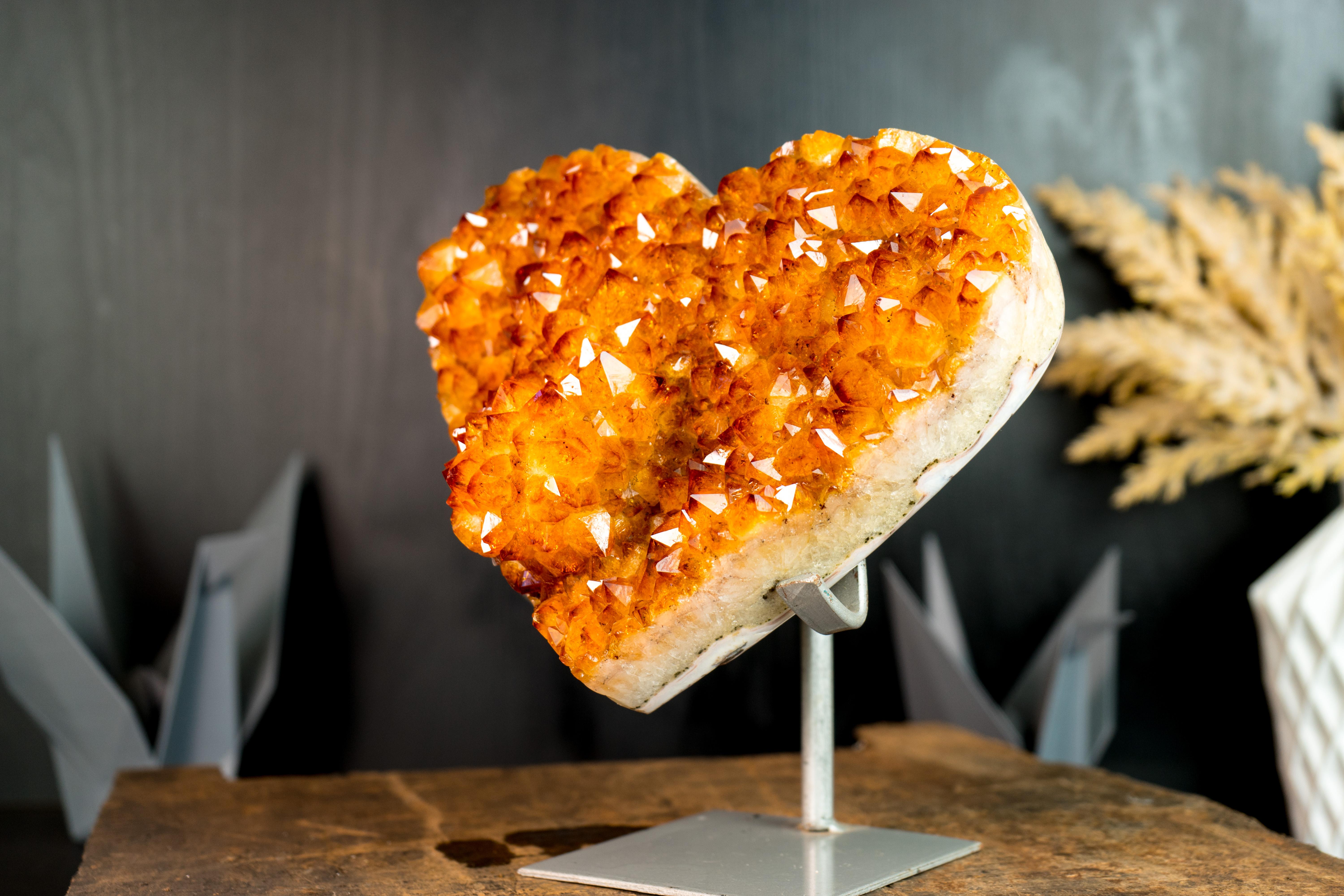 A natural masterpiece, this Citrine Heart brings a flower rosette that seems ready to blossom into radiant beauty, making it the perfect addition to your space or a special gift for someone special.

The specimen brings a high-grade (AAA) golden