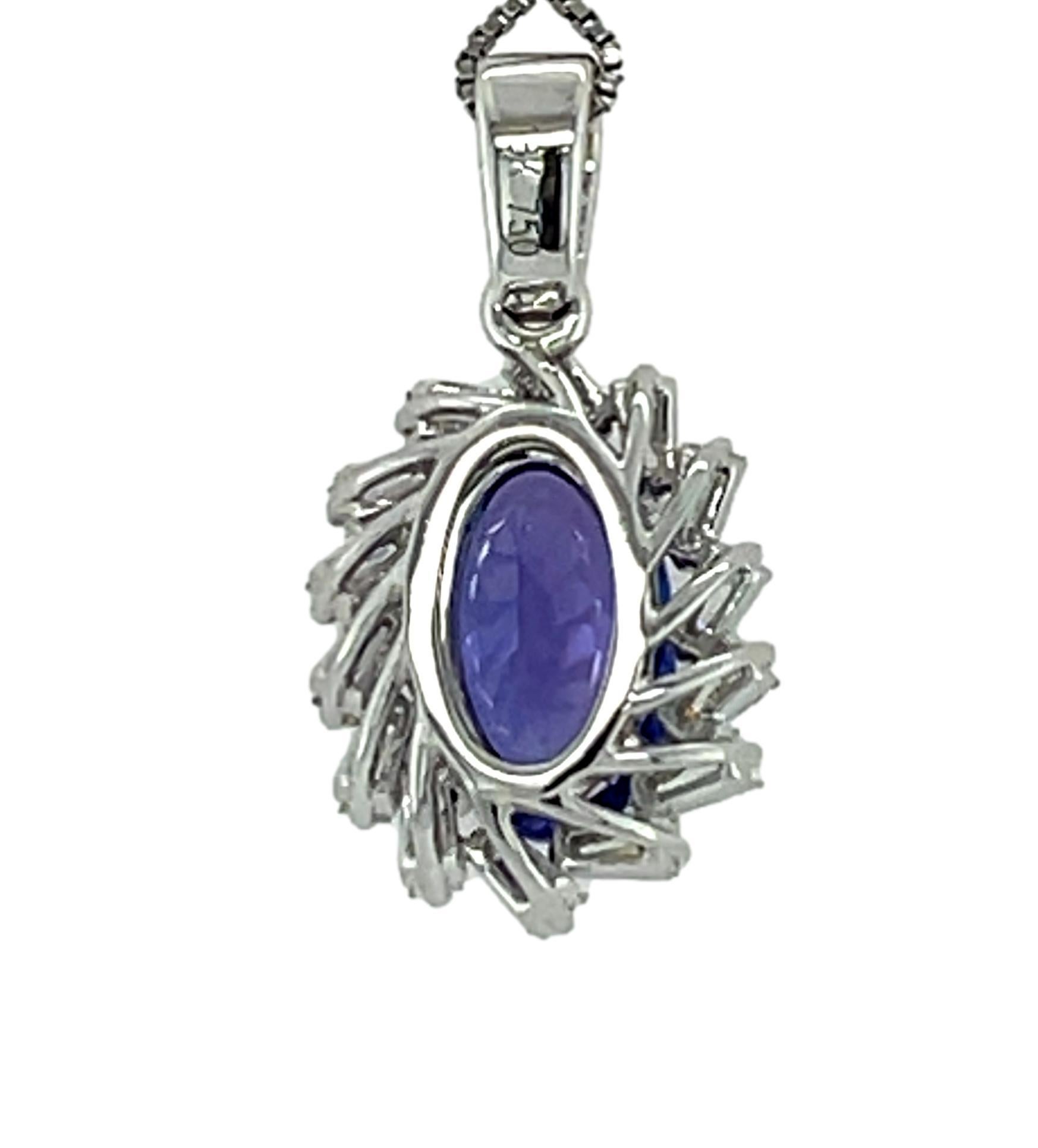 This stunning Tanzanite and diamond pendant is beautiful to wear on that special occasion. It has a 10x6 mm oval cut AAA quality Tanzanite with 4 prong setting in 18 karat white gold. There is a halo of 20 sparkling tapered baguette diamonds