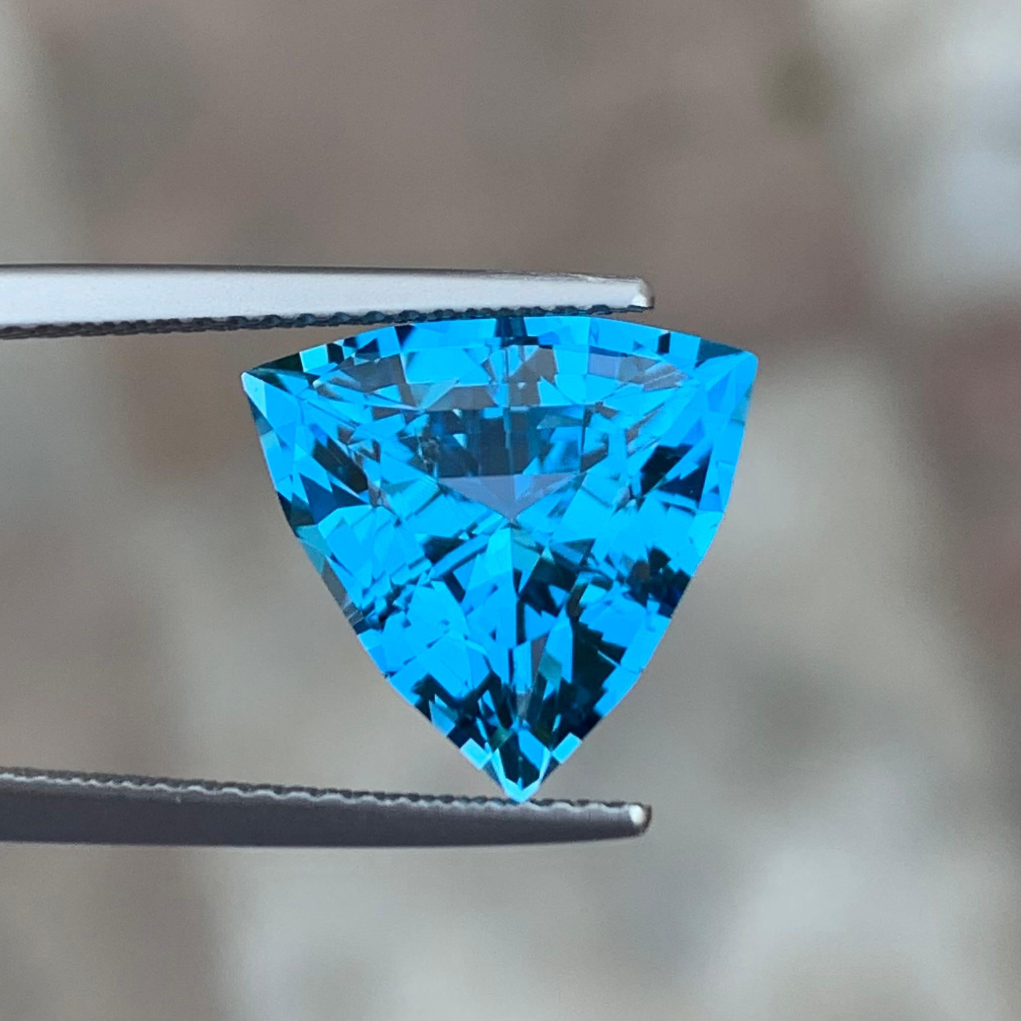 Gemstone Type : Faceted Electric Blue Topaz 
Weight : 7.20 Carats
Dimensions : 12.1x12.6x7.9 Mm
Origin : Brazil
Clarity : Eye Clean
Shape: Trillion
Color: Blue
Certificate: On Demand
Blue Topaz Metaphysical Properties
Blue topaz, in particular, is