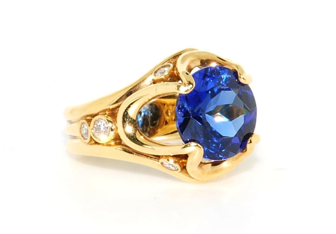 Everything about this spectacular 5 carat vivid blue Tanzanite ring is good as it gets. Rich 11.9 grams of  buttery 18 karat yellow gold holds this stunning AAA quality center stone.  It has a lab report from PGS in Chicago, and measures 10.65 x