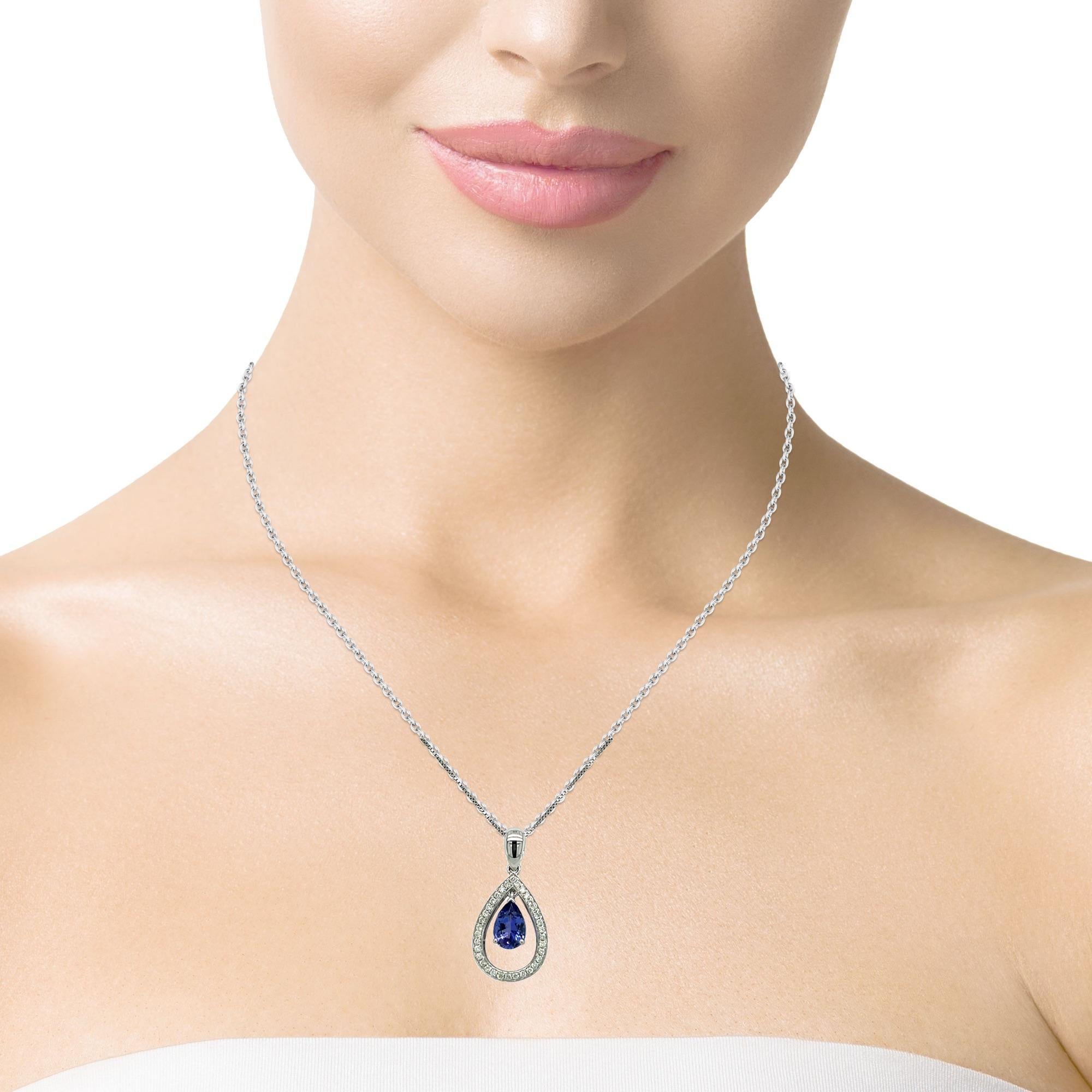 This stunning solitaire tear drop AAA quality Tanzanite pendant is surrounded by top quality shimmering brilliant cut diamonds. Comes with a gold chain. Pendant is brand new with tags attached. It comes in a beautiful box ready for the perfect