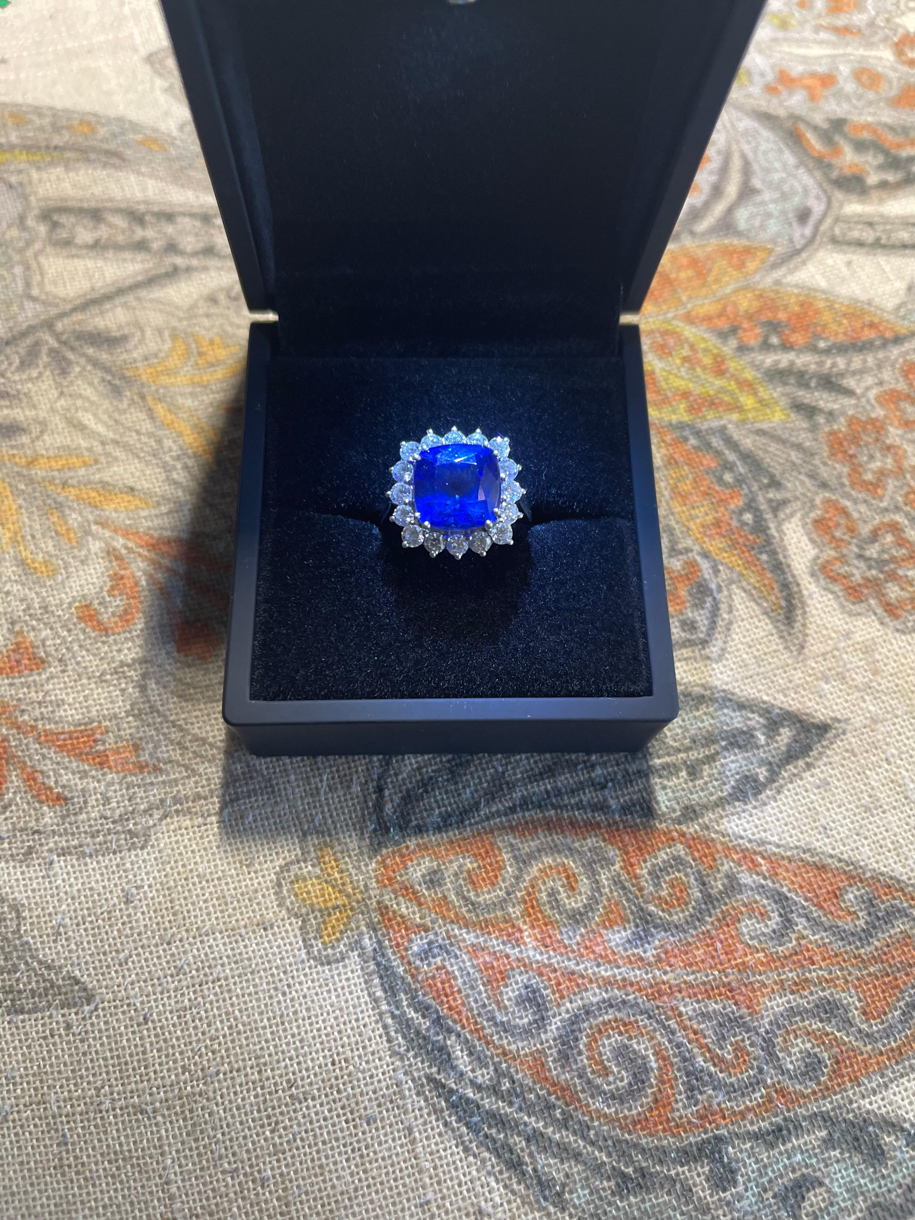 This ring is a stunning example of the best Tanzanite the mines ever produced.  This stunner is set in platinum with a 9.00 ctw Vivid/AAAA/Block D cushion cut Tanzanite with rich blues and purples and 16 sparkling diamonds (1.40 ctw) with E/F color
