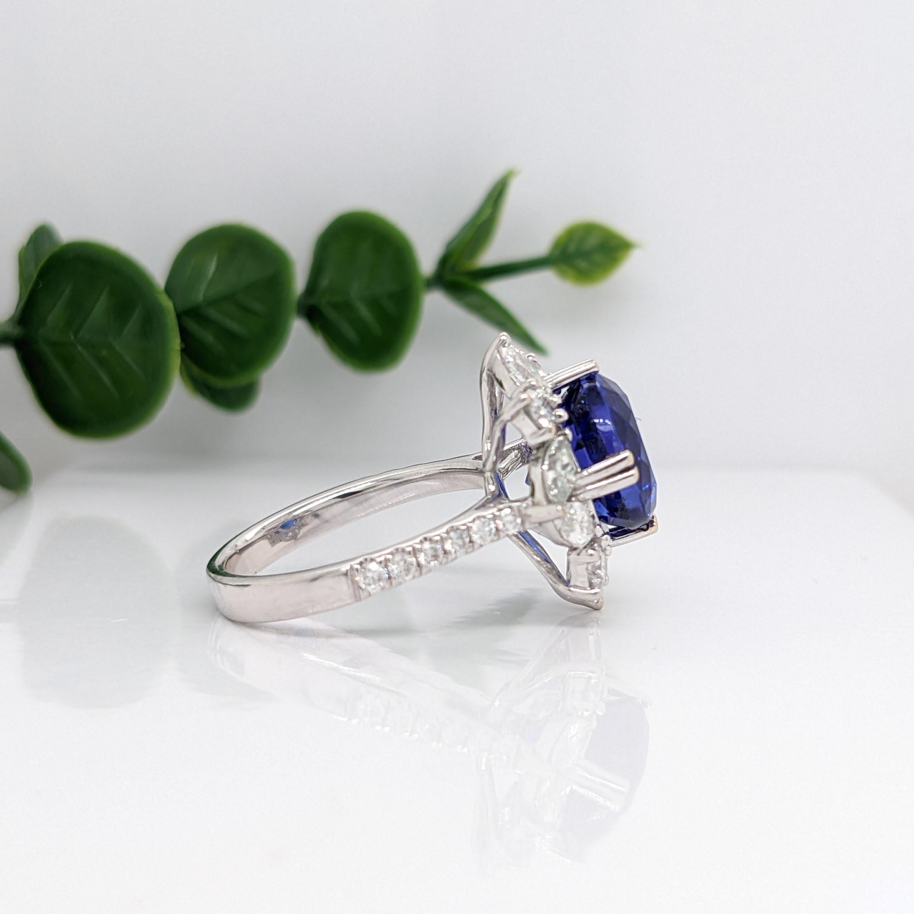 This stunning ring features a vibrant AAA Tanzanite with purple and red flashes set in 14K white gold with marquise diamond accents. This cocktail ring makes for a stunning accessory to any look!

A fancy ring design perfect for an eye catching