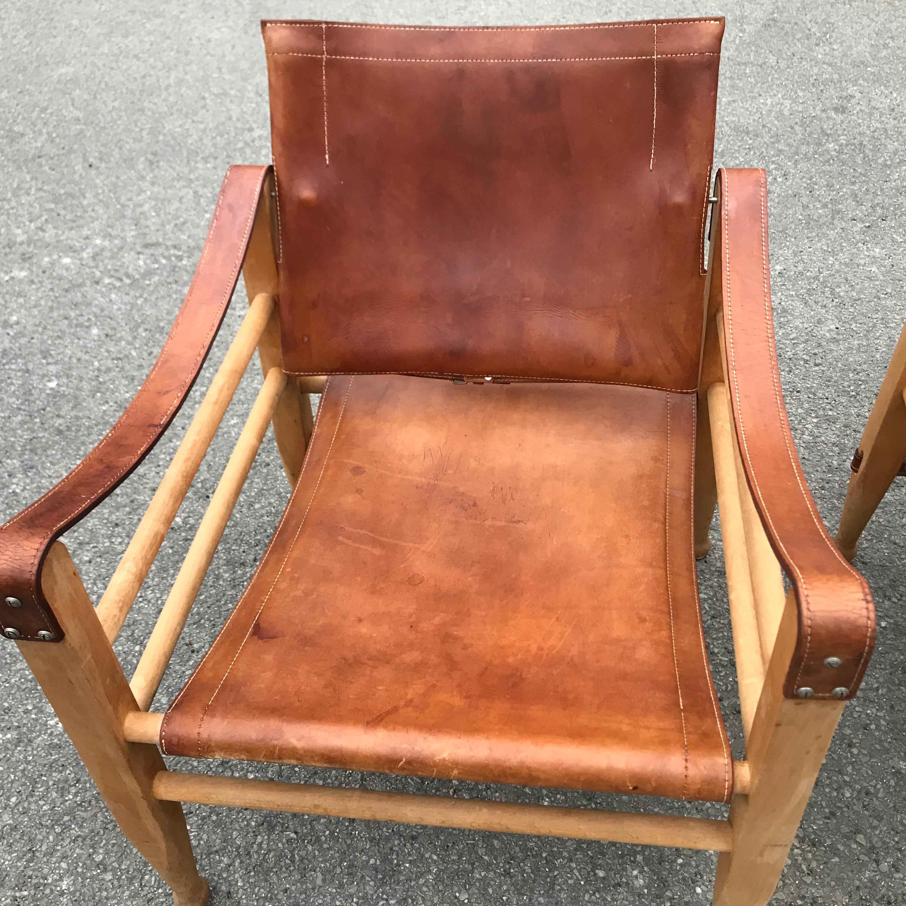 A pair of rarely seen Mid-Century Modern Danish 1960s Safari chairs by Aage Bruun and Son, in beechwood and tan or cognac natural leather. In very good original vintage condition, with a lovely patina.