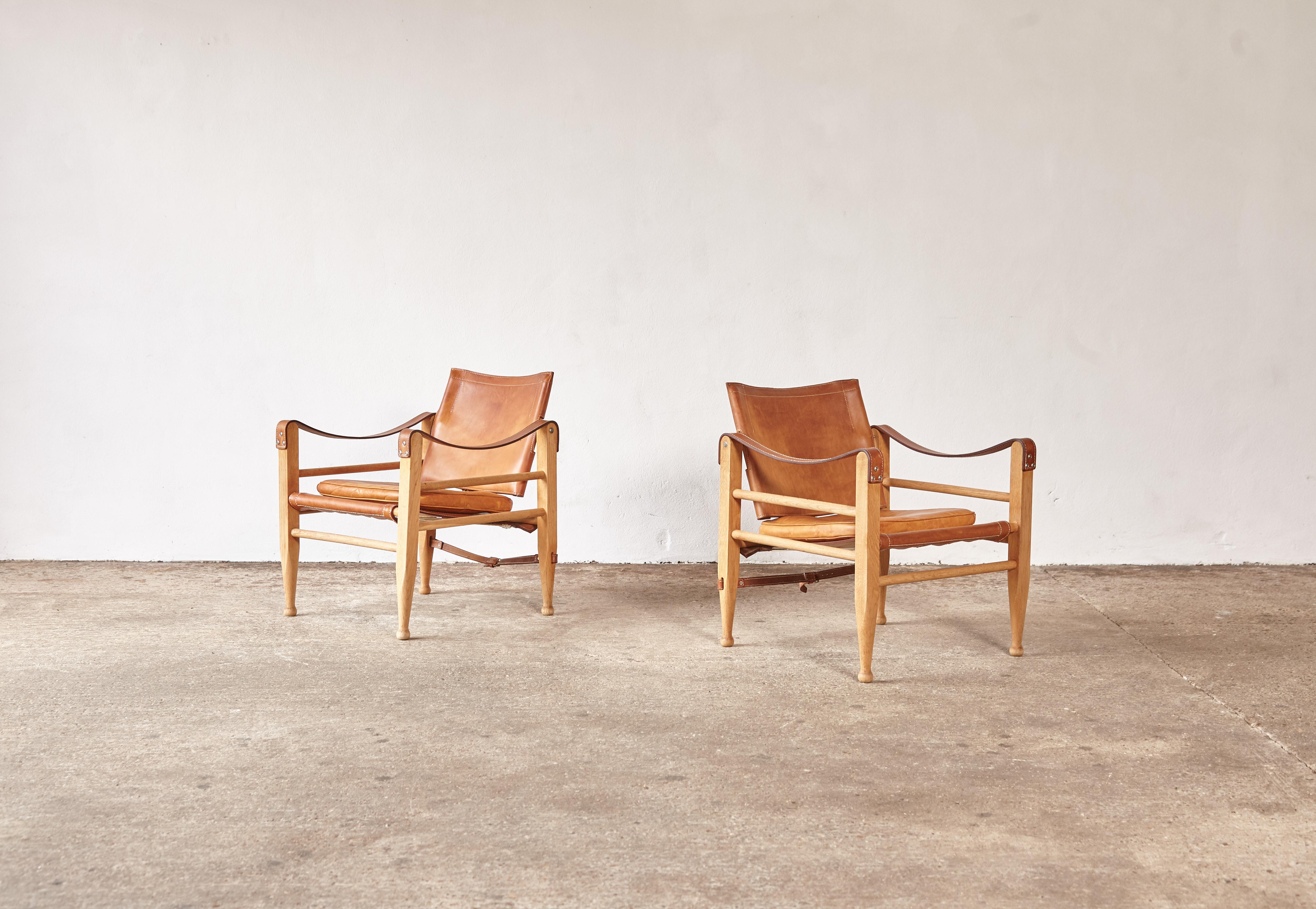 A pair of 1960s Safari chairs by Aage Bruun and Son, Denmark, in beechwood and tan or cognac natural leather. In very good original vintage condition, with a lovely patina.


  