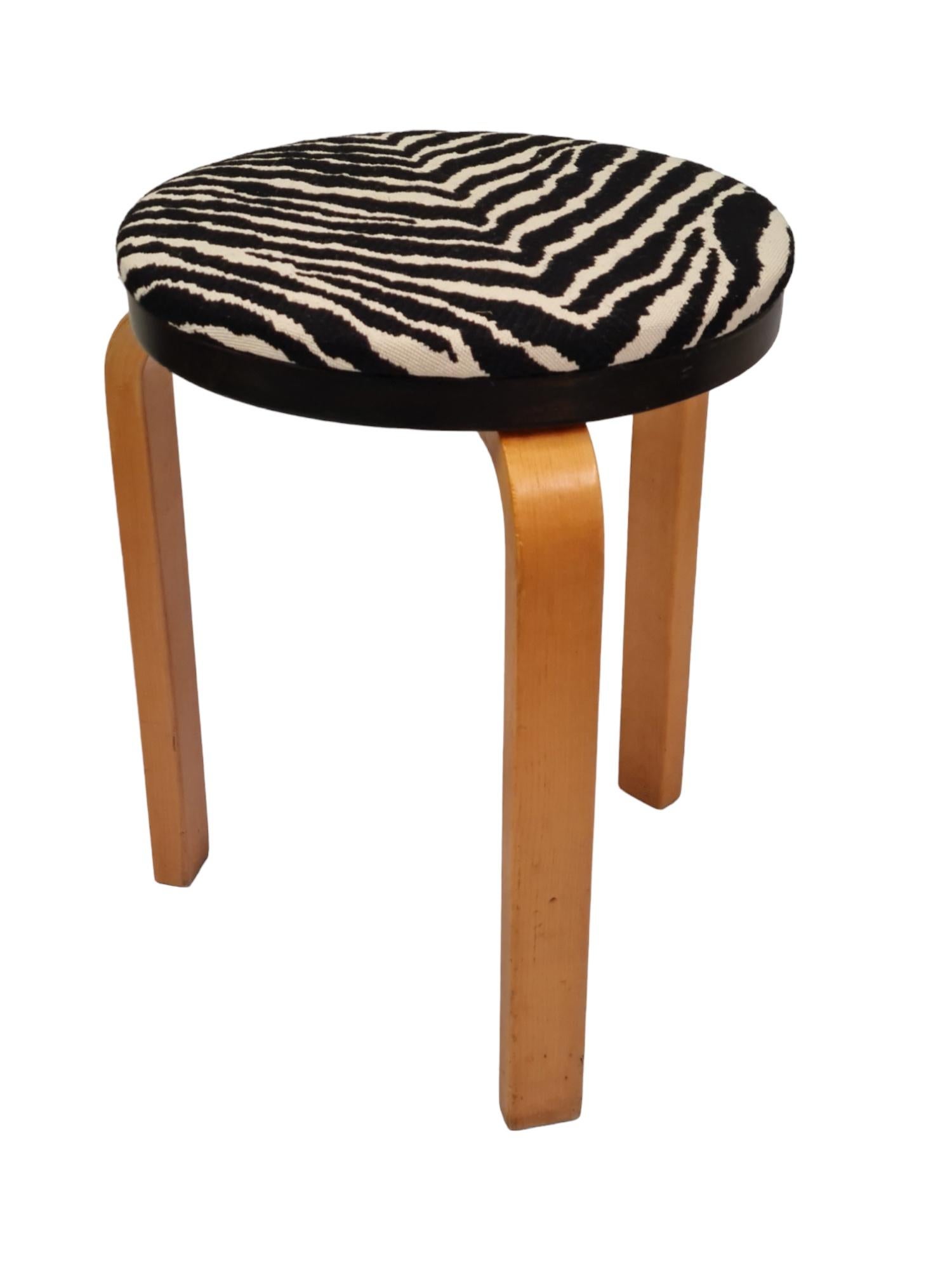 Yet another version of the Aalto famous 3-legged stool. This one is upholstered with original Artek zebra motif fabric. 
Aalto stools are quite desired in our opinion for their functionality and simplicity.  They are sturdy and firm to sit on,