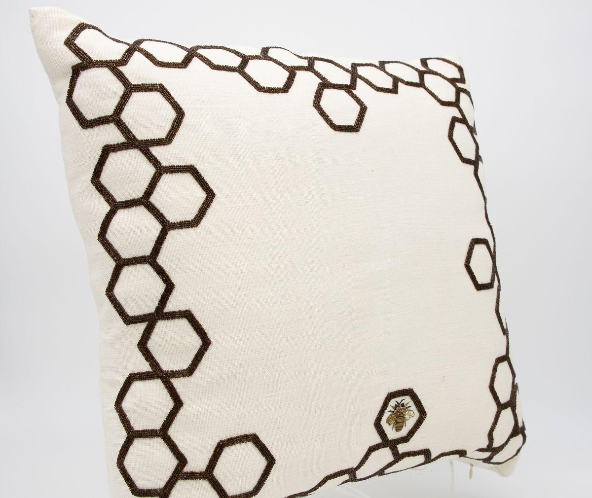 A wonderful hand-beaded pillow. Deep golden toned beads are sewn on a white linen to create an intricate honeycomb pattern along the edges of the pillow. One honeybee is centered within a single honeycomb shape. The reverse is made of the same