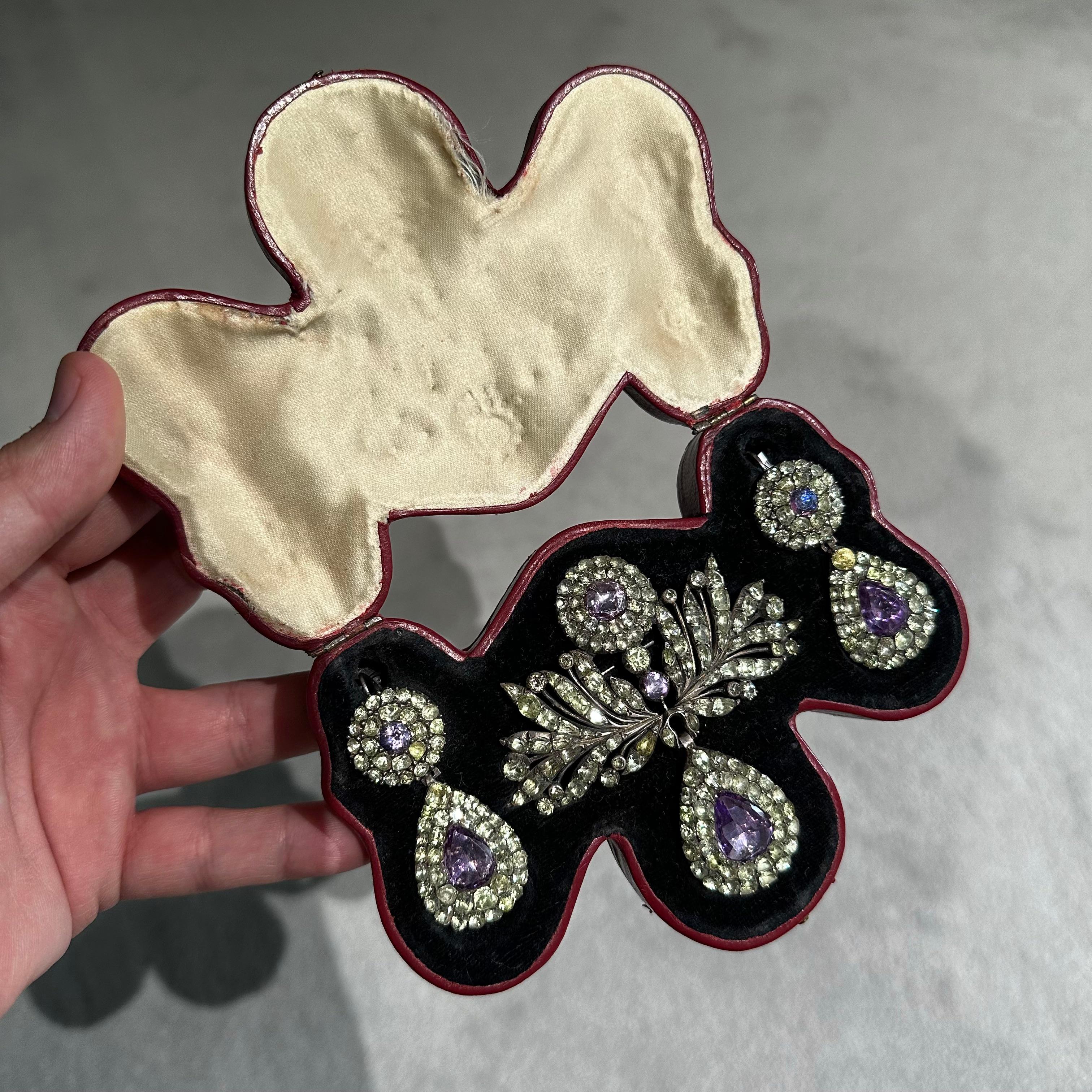 Antique 19th century chrysolite chrysoberyl amethyst quartz foliate pendant/brooch and drop earrings demi-parure mounted in closed-back silver, Portuguese, late 1800s, in a fitted case. A popular design with collectors of Georgian and Victorian