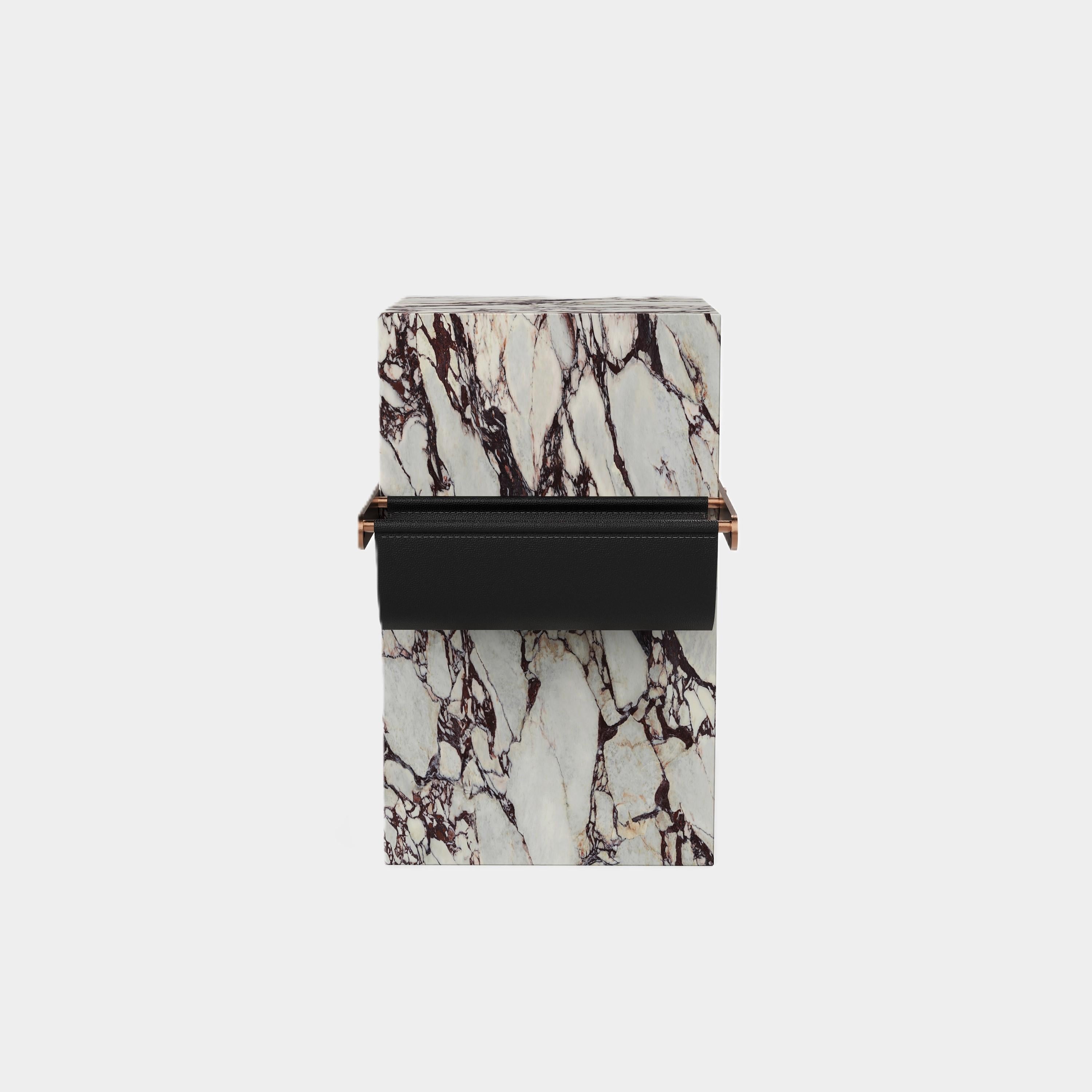 A contemporary side table, crafted from solid marble with intricate natural patterns. Its sculptural design offers dual purpose as a side table as well as providing a unique way to organise and display your favourite magazines or books.

The black