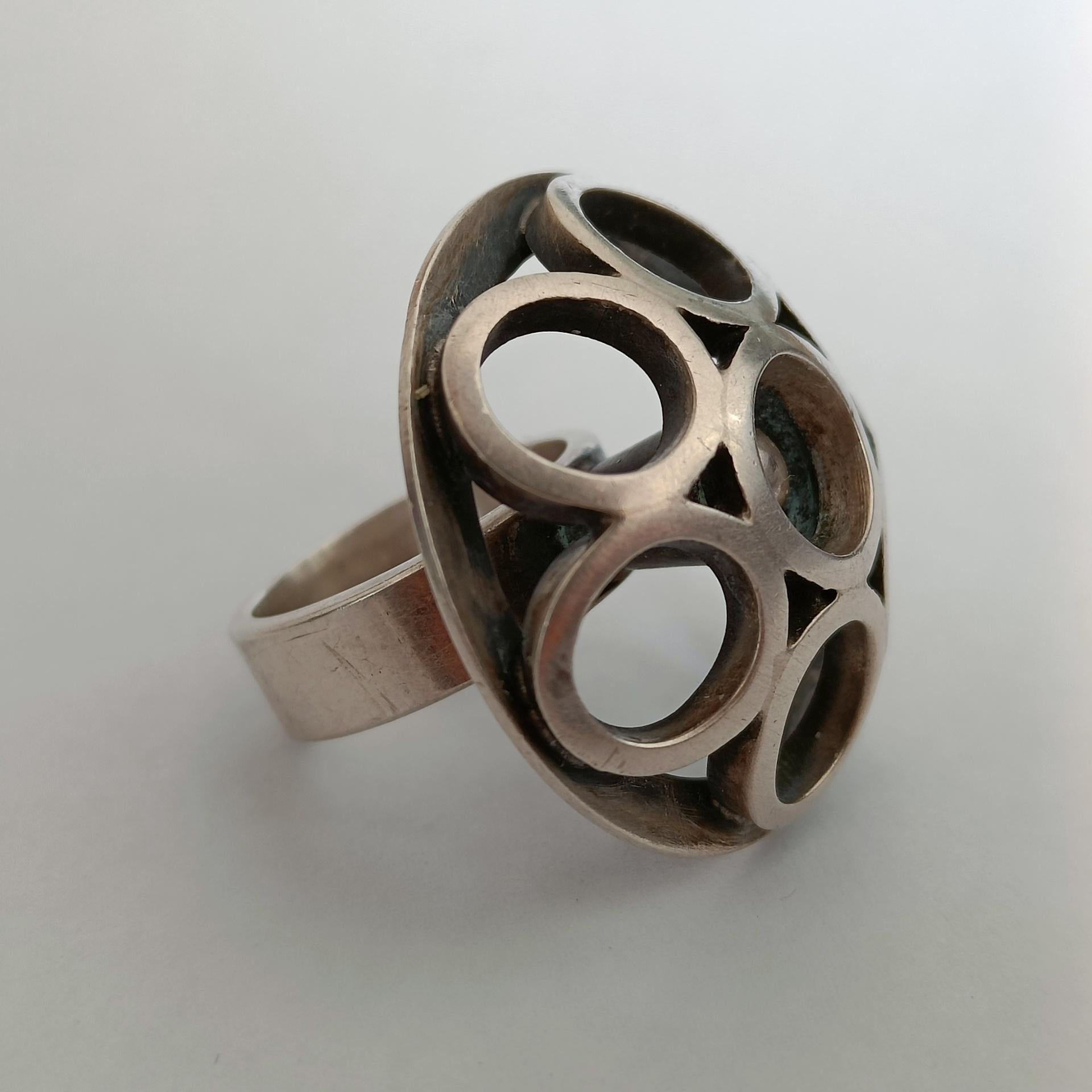 Large geometric silver ring by Aarikka.
Designed by Alpo Jääskeläinen, Helsinki, Finland 1960s.

Hallmarks:
Aarikka
Finland
AAJ (Alpo Jääskeläinen's mark)
a crown in heart (Finnish mark)
916 H (silver purity 916/1000 and H for 