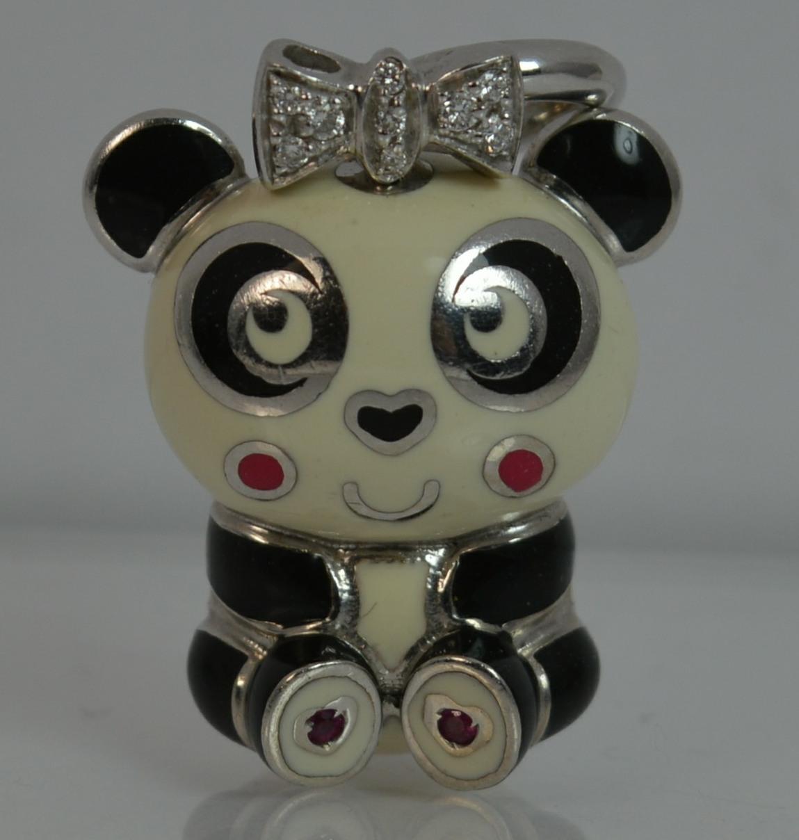 

A stunning genuine AARON BASHA charm or pendant.

Solid 18 carat white gold example.

Designed with black, cream and red enamel with diamonds to the bow top.

Formed in the shape of a cute panda.

No longer a current model though based on similar