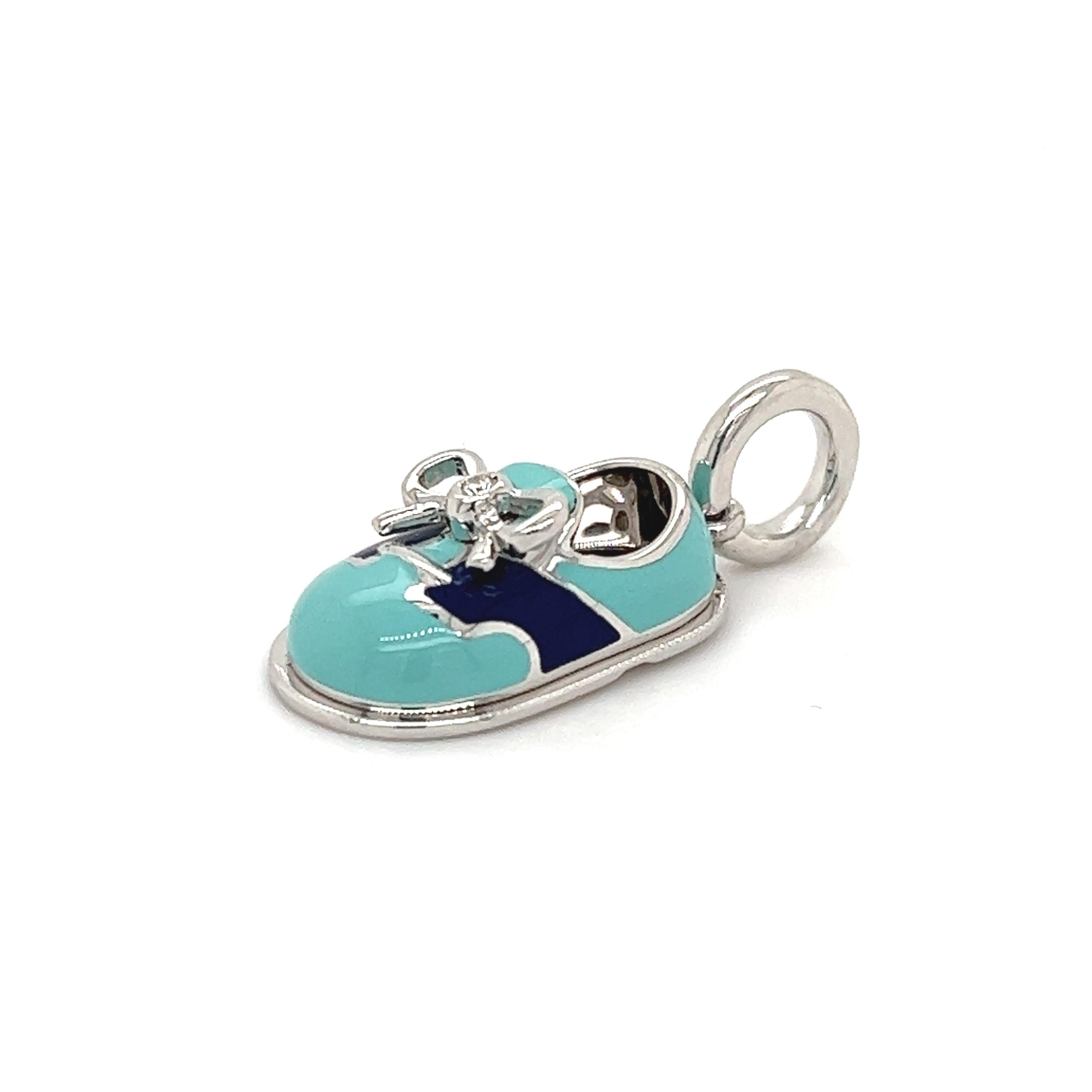 Celebrate a sweet milestone with the help of this opulent Aaron Basha pendant. Shaped like a baby shoe, this piece measures 1” long and is accented by charming blue and aqua enamel. It’s made from lustrous 18k white gold and can be attached to any