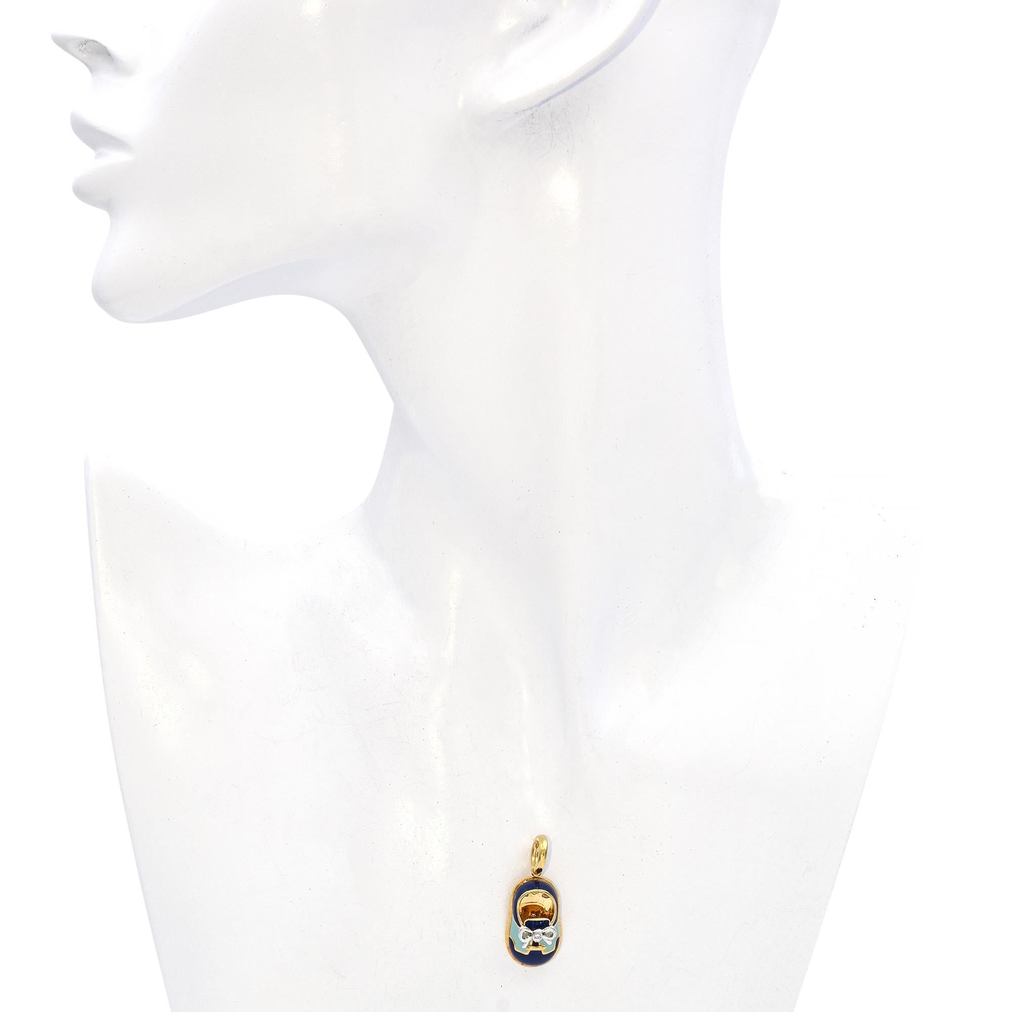 Charming Aaron Basha 18K Gold and Enamel Baby Shoe Charm with Diamond Accent. This delightful charm is crafted in 18k gold with vibrant enamel detailing. The design features a miniature baby shoe adorned with a white diamond at the center of a